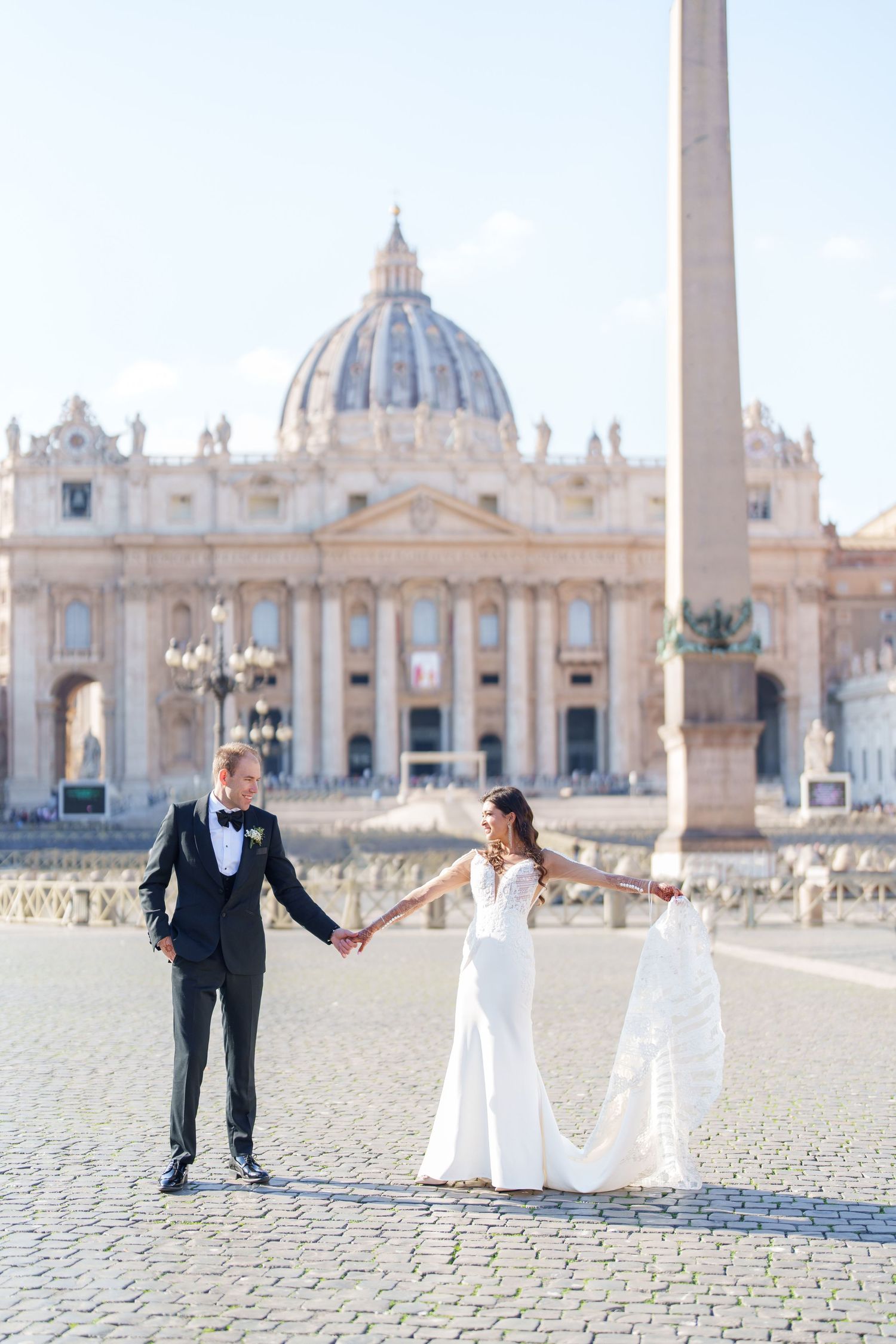 Wedding photos captured in St. Peter's Square with the Vatican basilica dome in the background.