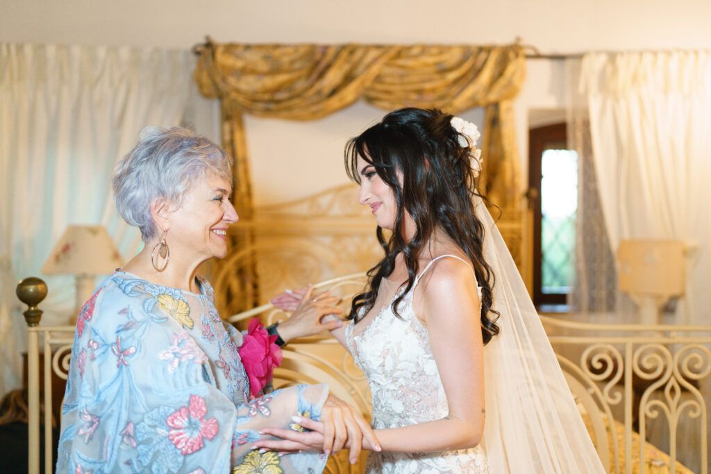 Wedding party members in light blue dresses sharing joyful moments during preparation.