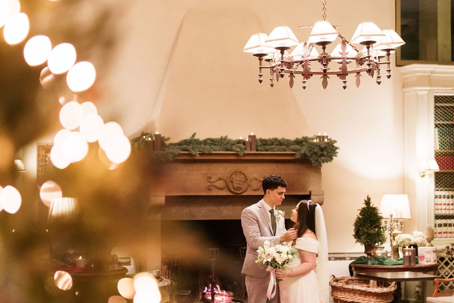 Elegant wedding reception venue with warm lighting and chandeliers creates a romantic atmosphere.