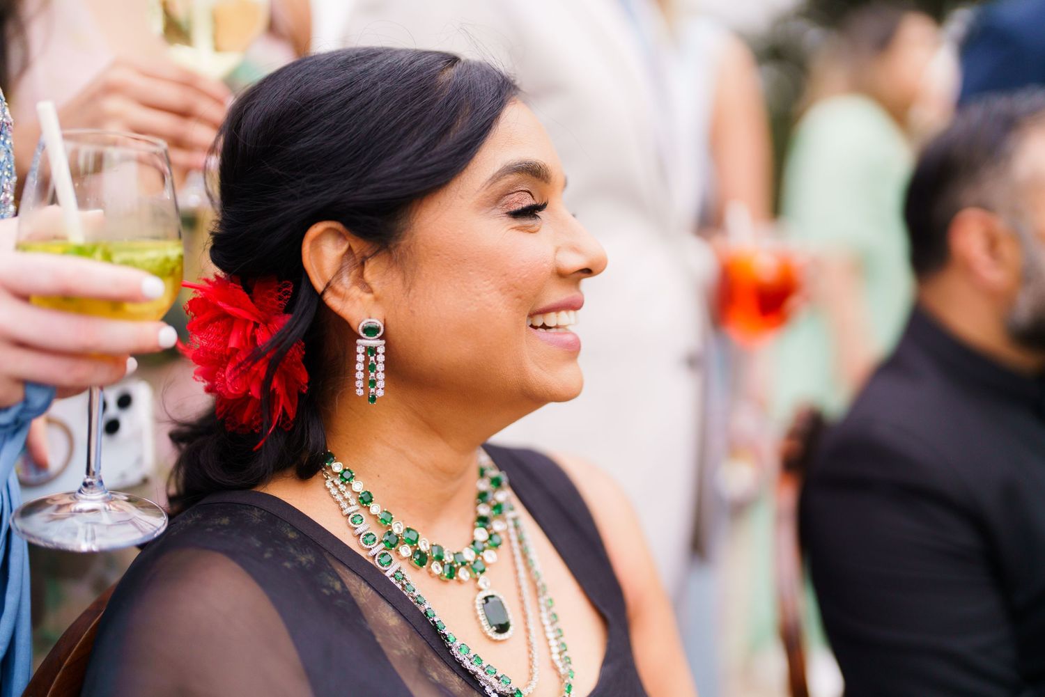 Guests enjoying drinks and conversation at an elegant outdoor wedding reception.