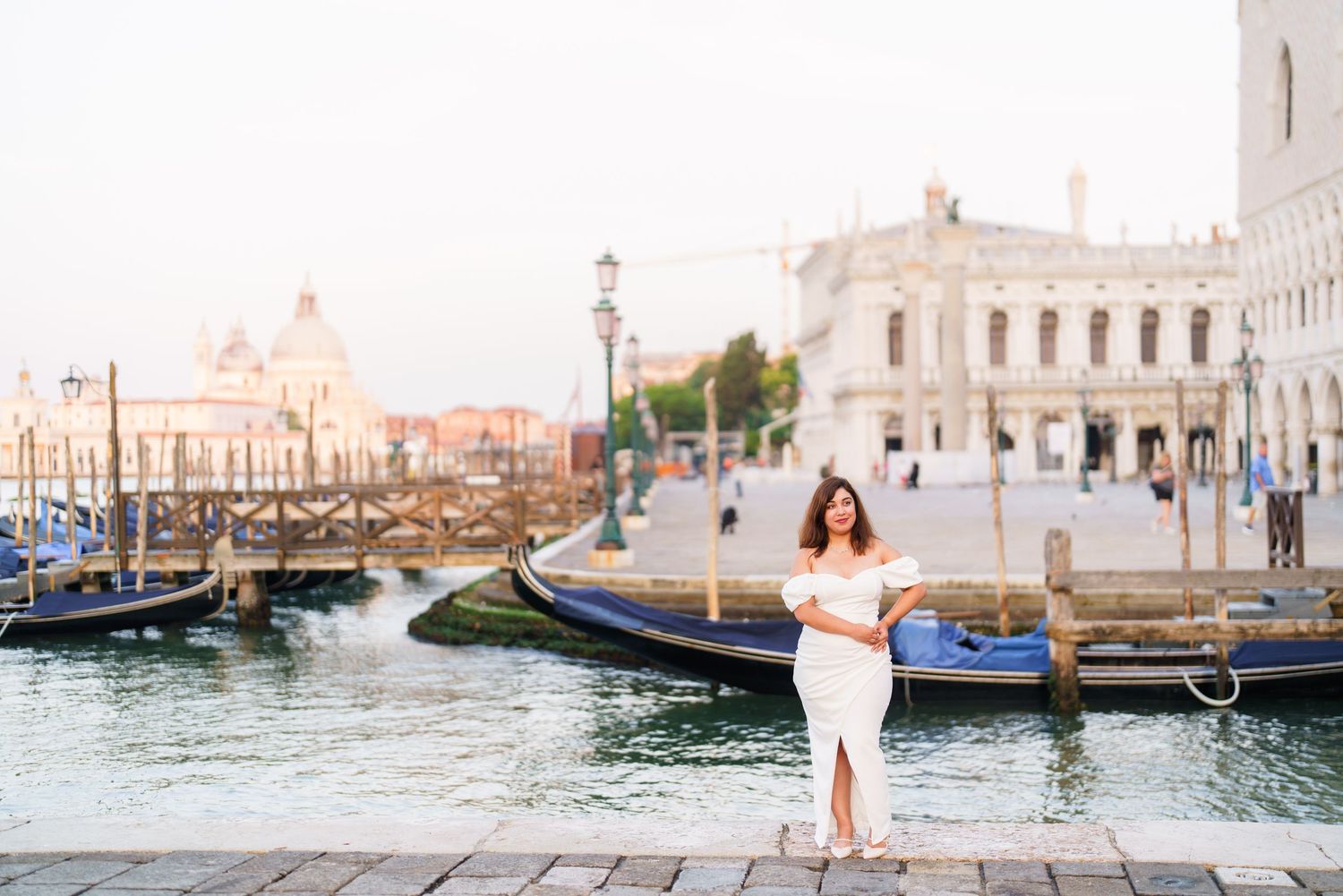 Romantic Venice travel scene with gondolas and historic architecture along the Grand Canal at sunset.