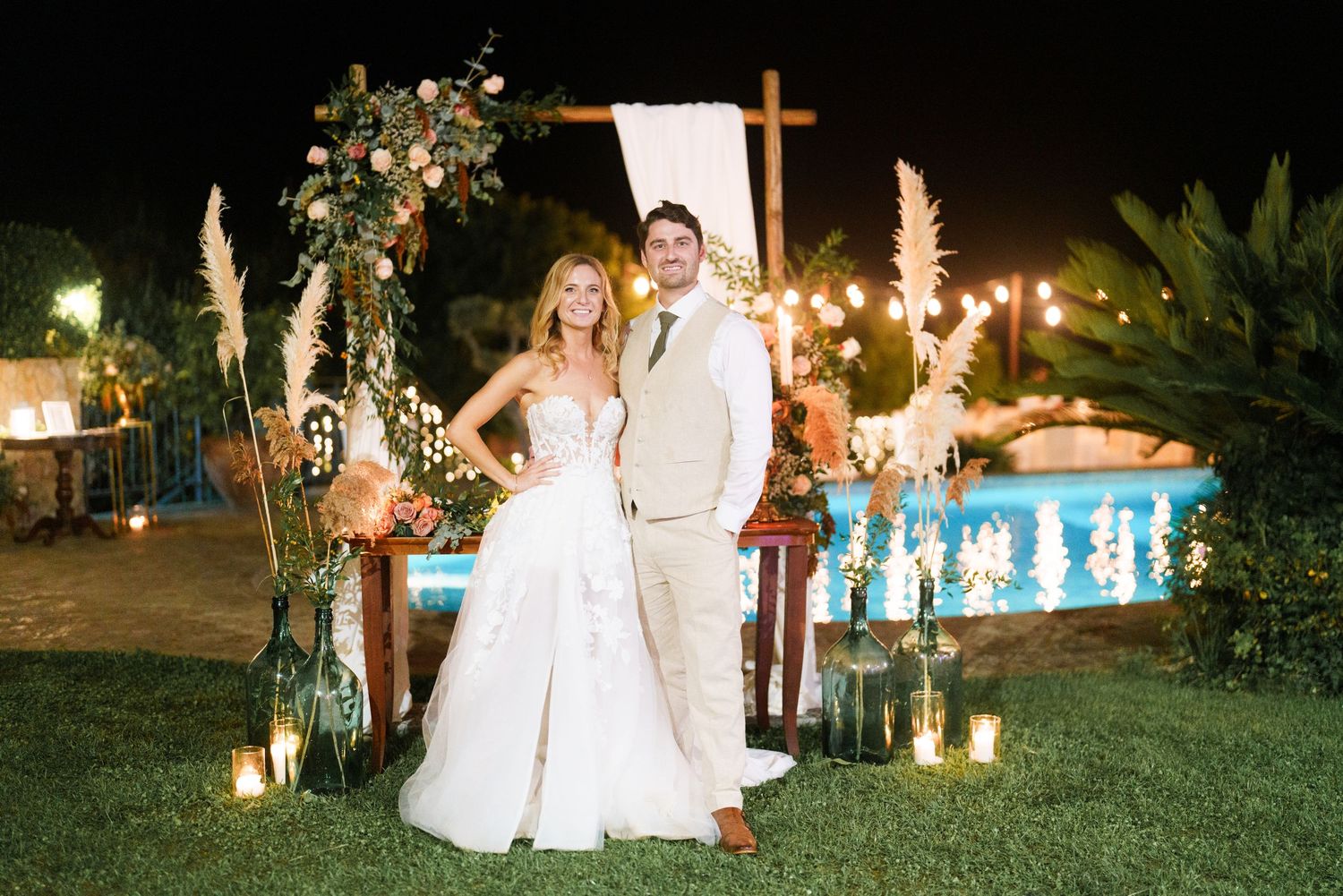 Evening wedding reception scene with string lights and fountains creating a magical atmosphere.