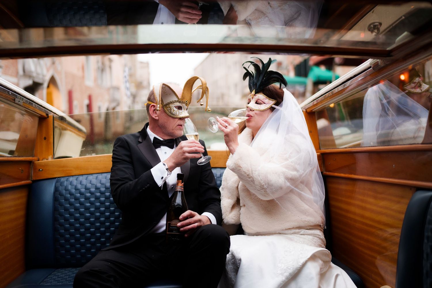 Couple in formal wedding attire shares an intimate moment while dancing together on a wooden dance floor.