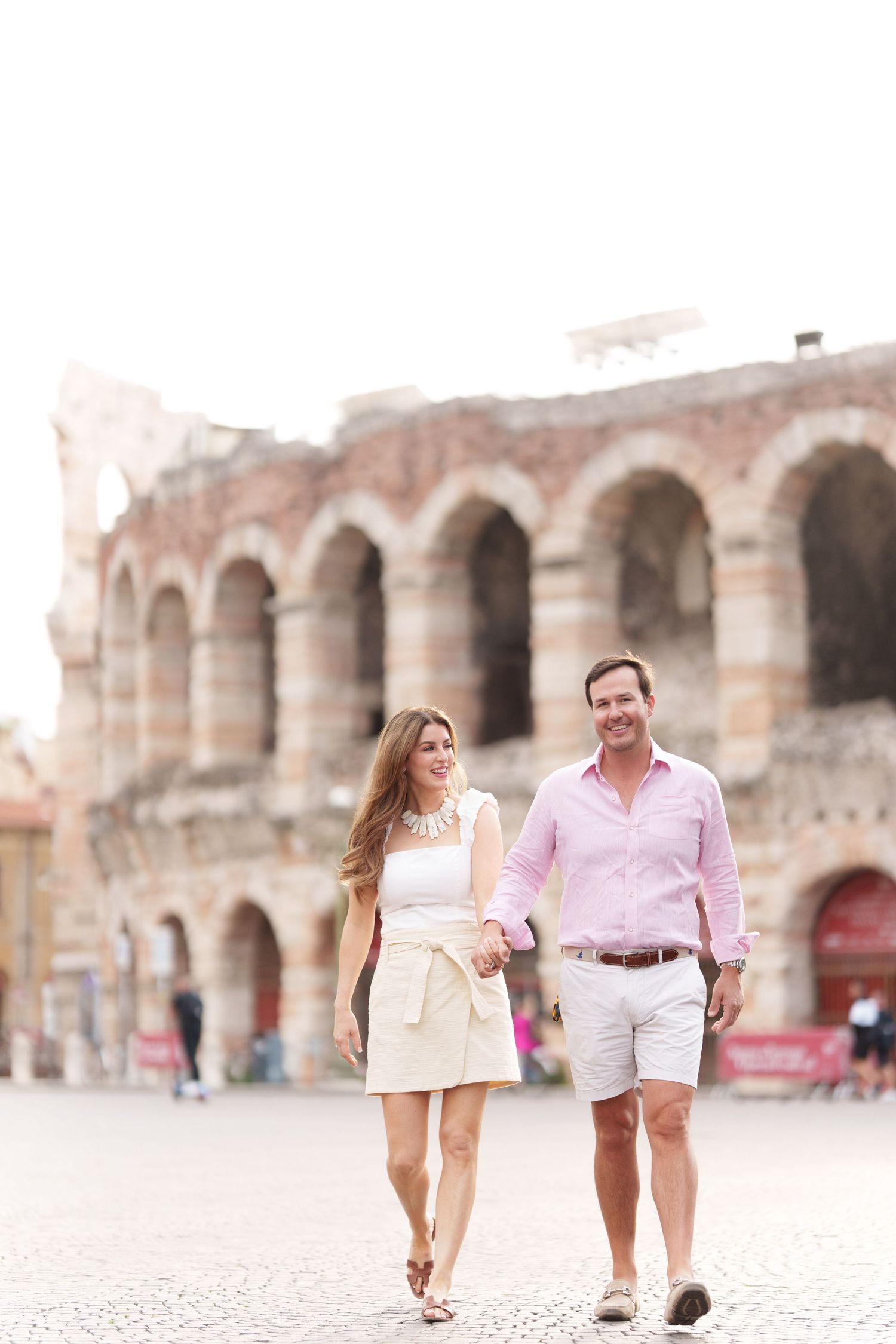 Verona family photographer family walking in front of Verona Arena Italy