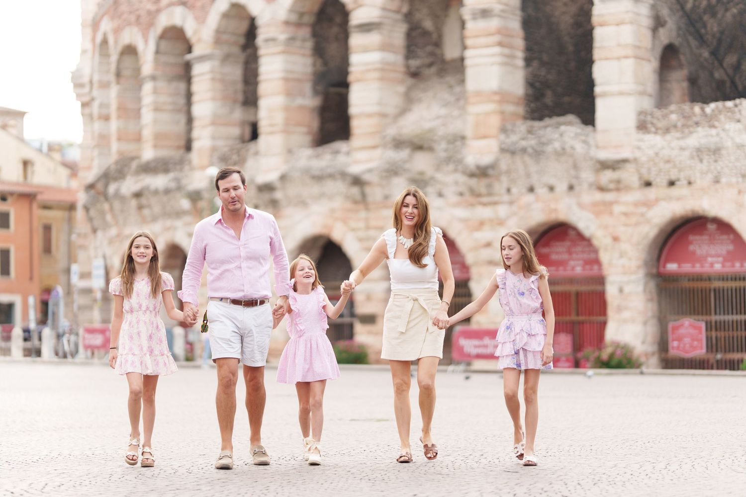 Verona family photographer family walking in front of Verona Arena Italy
