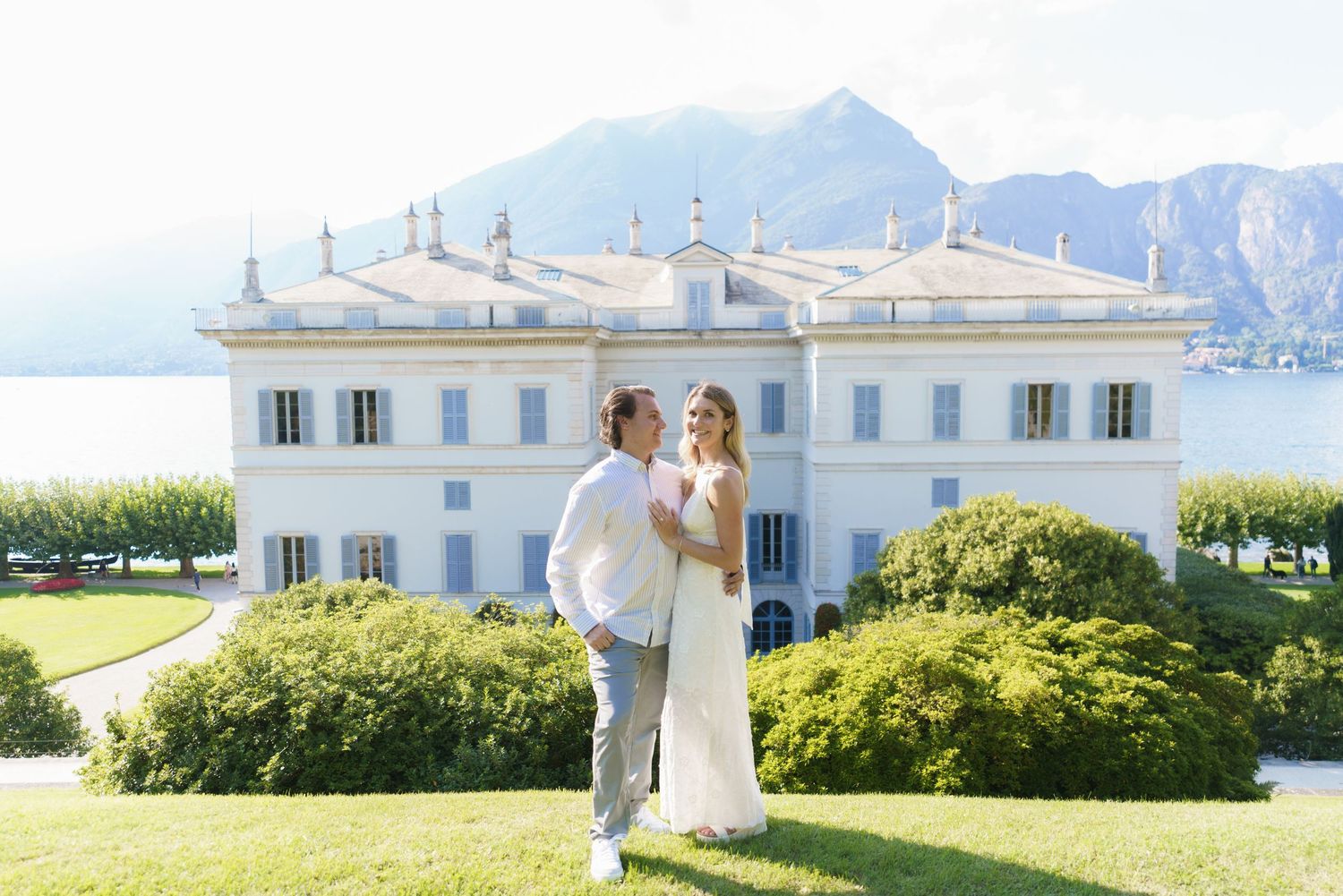 Elegant white wedding venue overlooking scenic mountain landscape with Mediterranean architectural details.