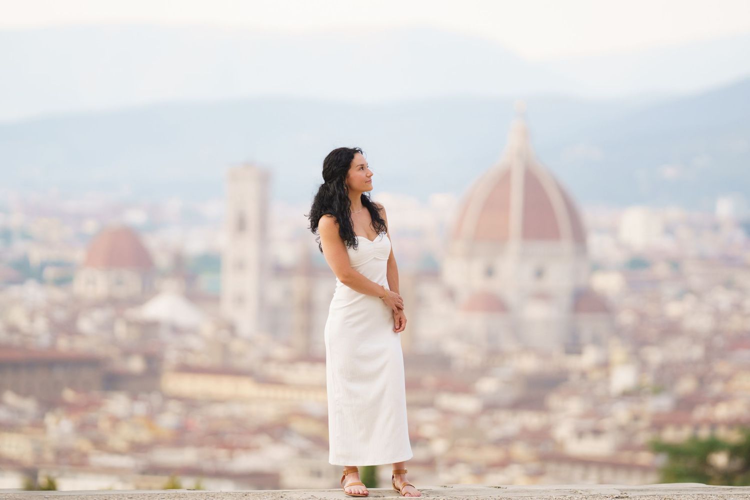 A panoramic view of Florence, Italy with the iconic Duomo cathedral dome rising above the terracotta rooftops.