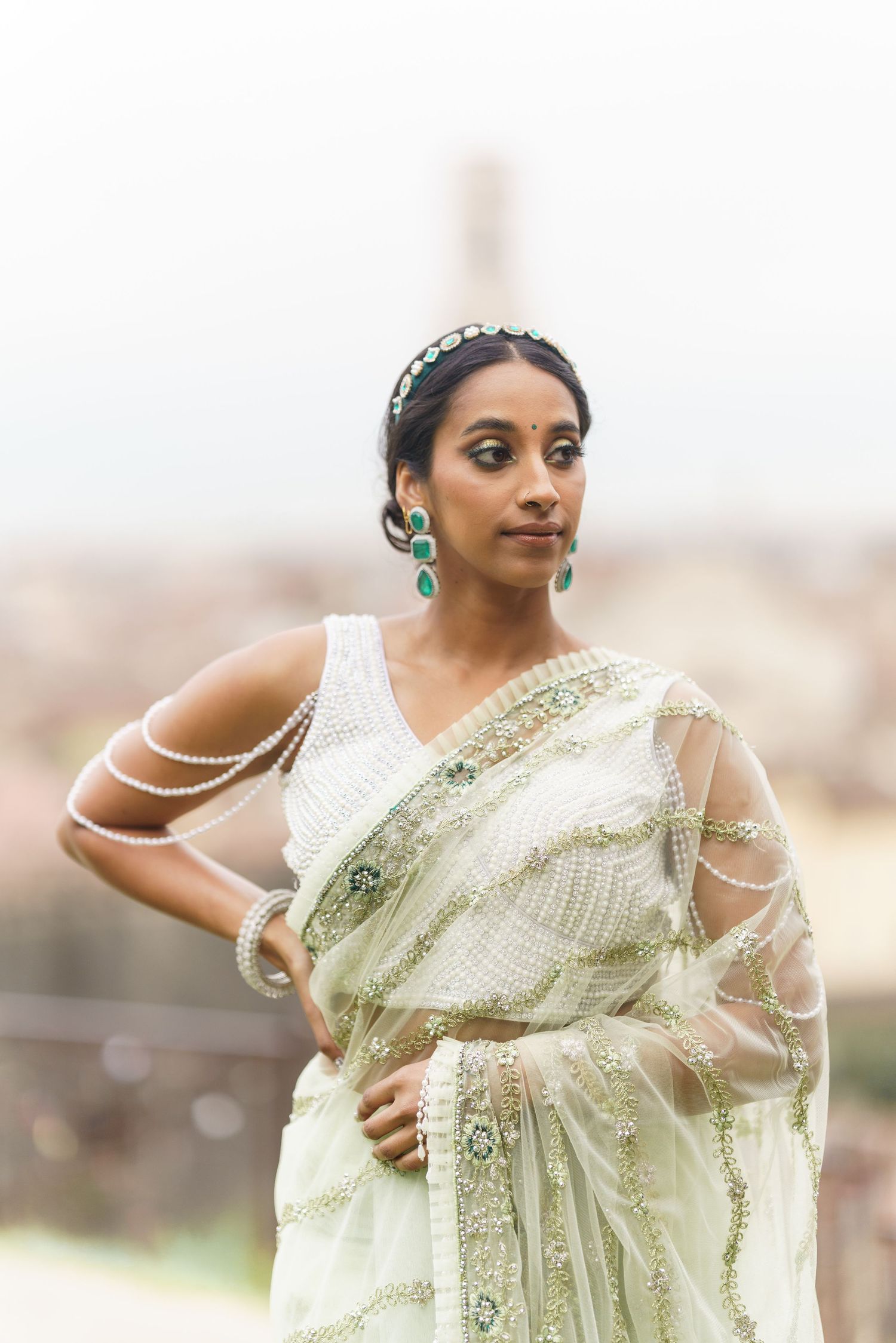 Woman in elegant pale green and silver Indian sari poses gracefully in multiple shots showing traditional South Asian style.