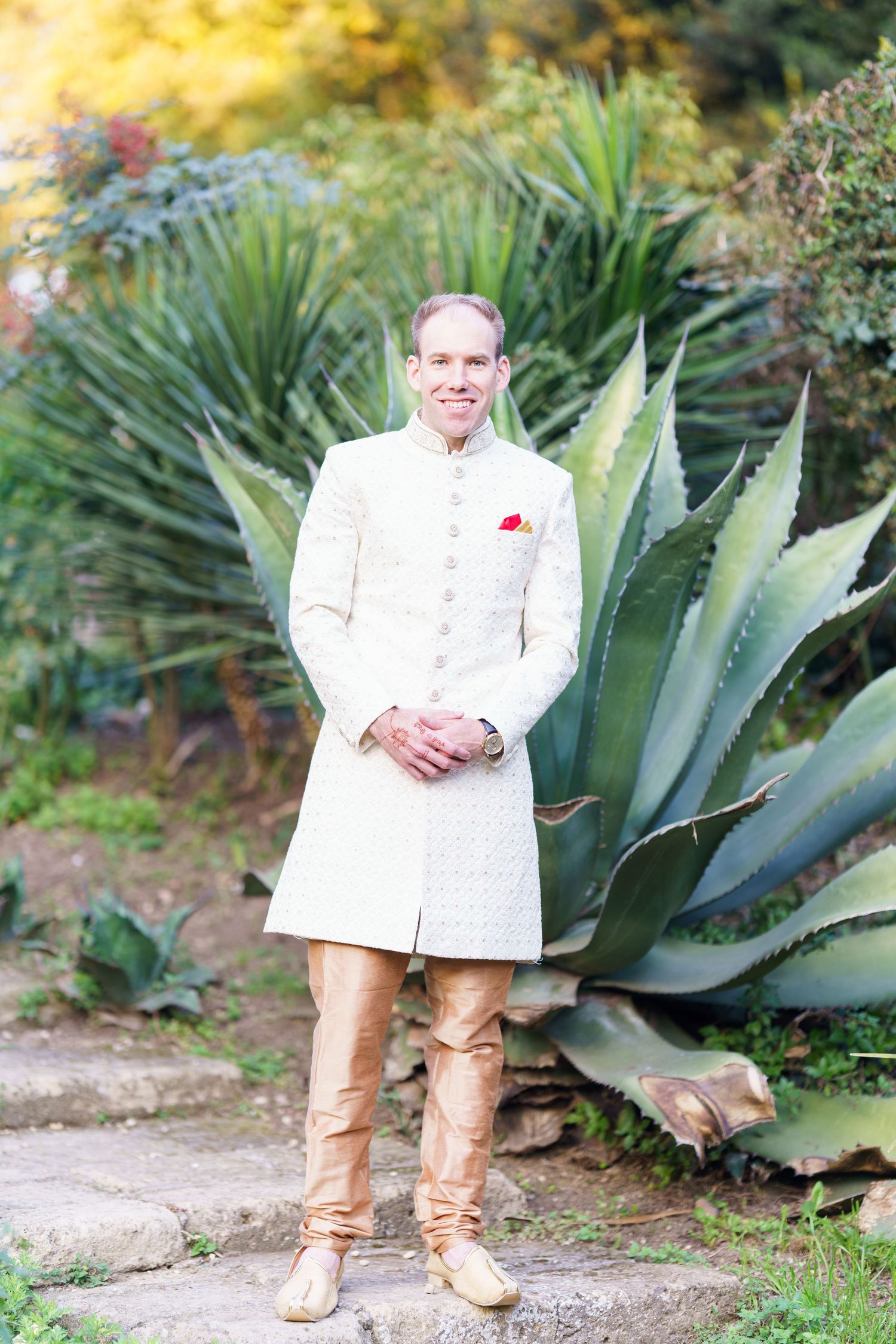Formal white wedding attire photographed against a backdrop of large agave plants.