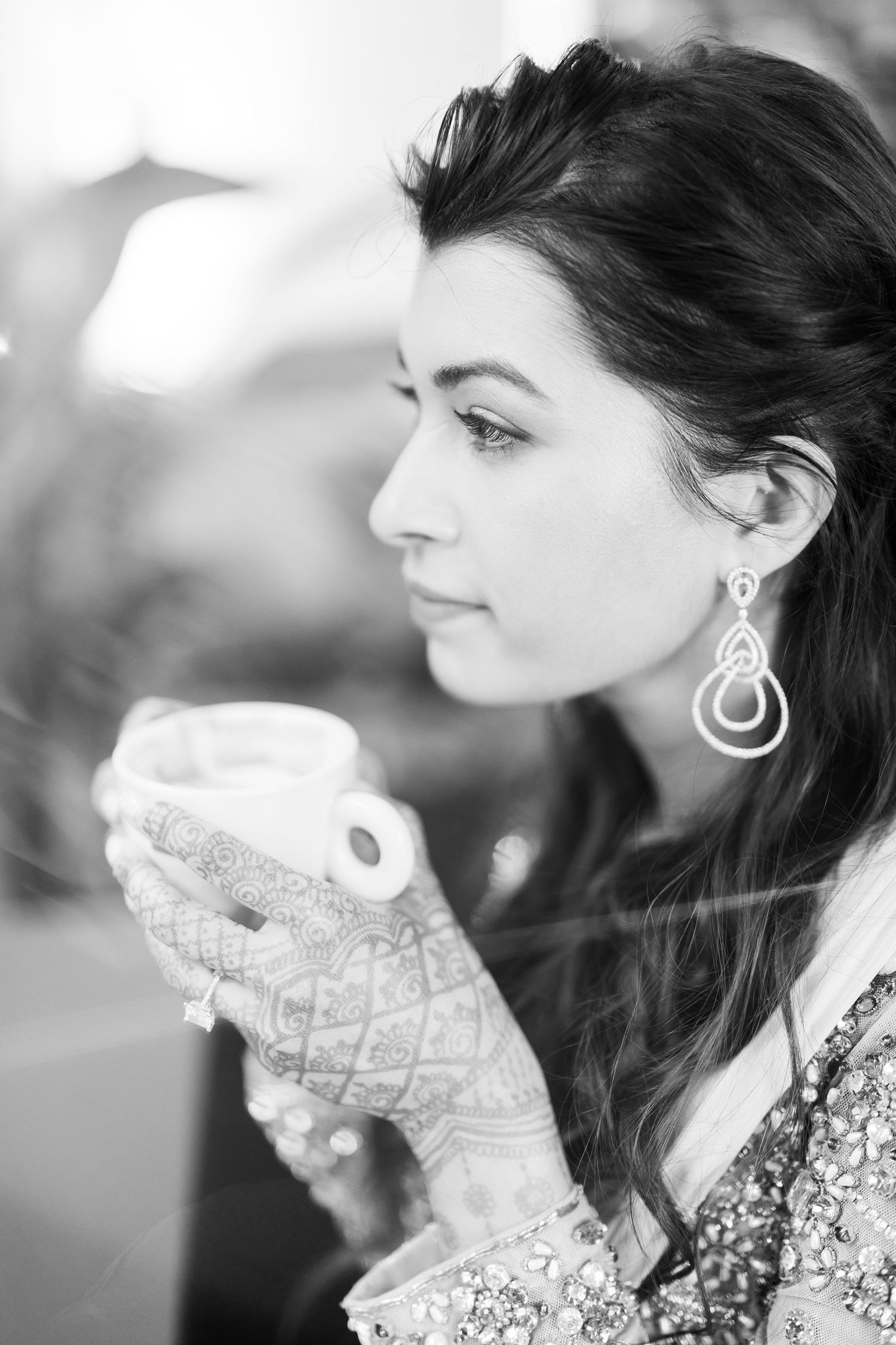 Black and white profile portrait showing elegant earrings and lace collar details.