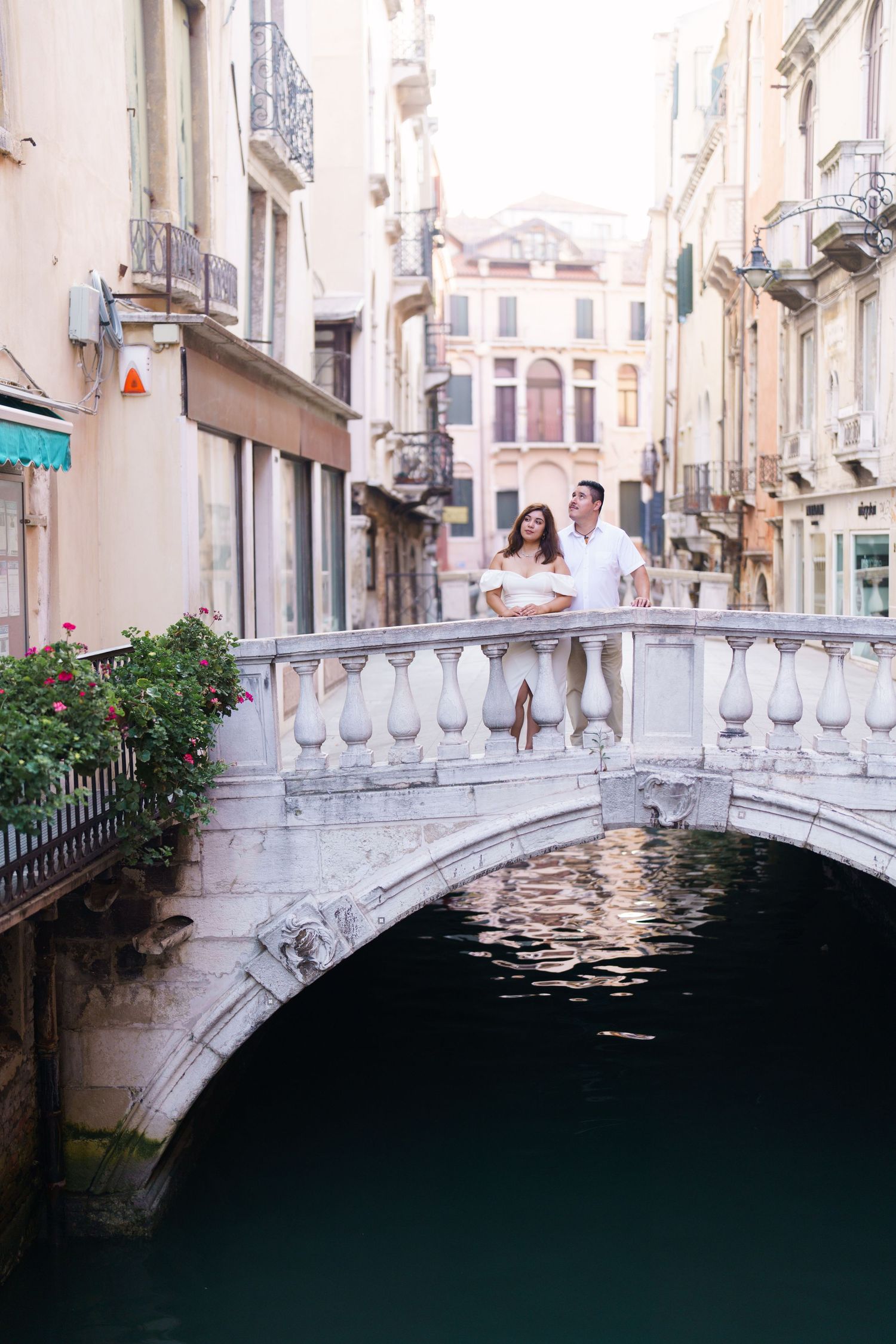 A series of photos showing a white ornate bridge over dark Venetian canal waters with historic buildings in the background.