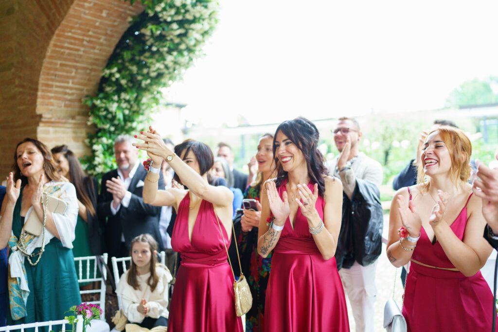 Wedding guests react with joy and excitement during celebration.