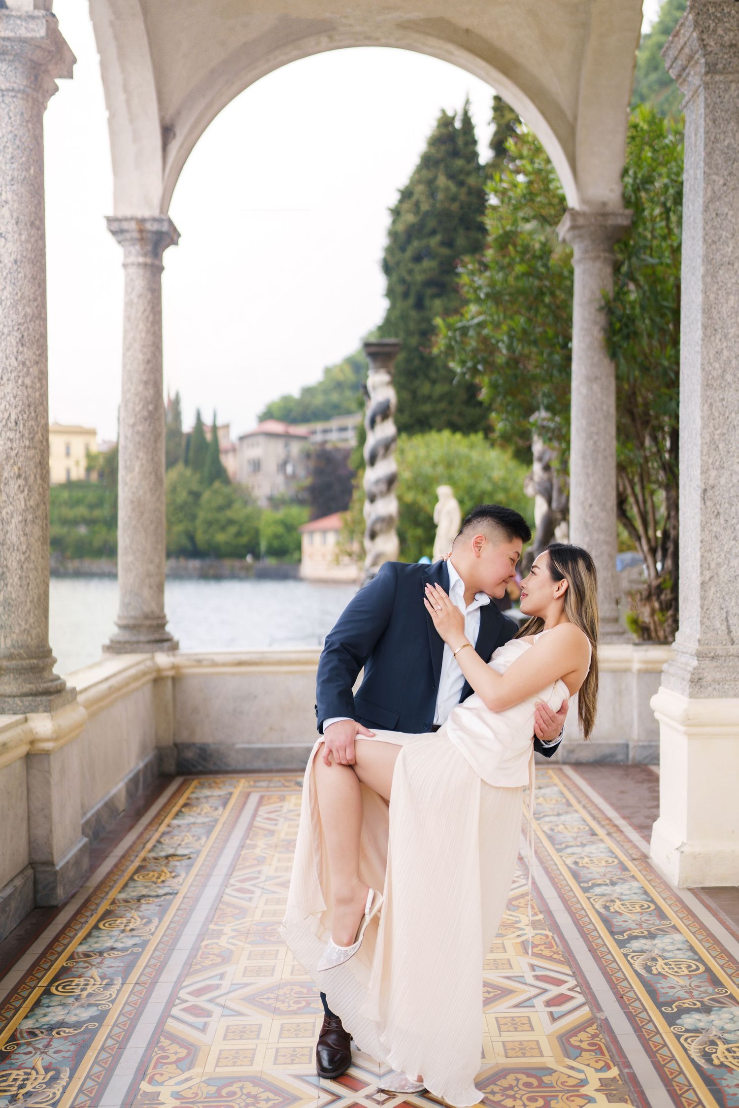 Lake Como proposal photographer capturing surprise engagement at Villa Monastero in Varenna
