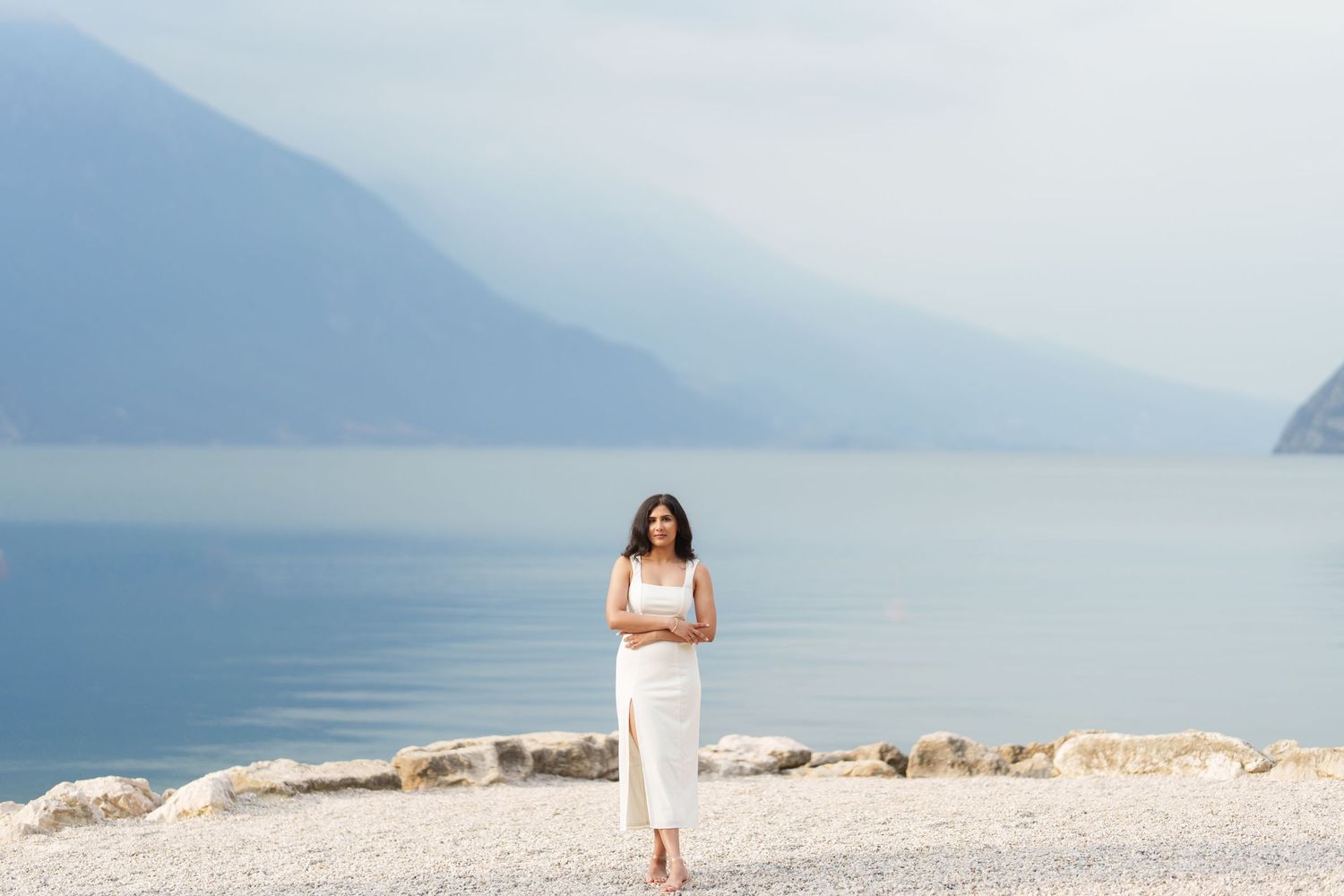 Seven serene landscape photos of Lake Garda in Italy show misty mountains and calm waters at different times of day.