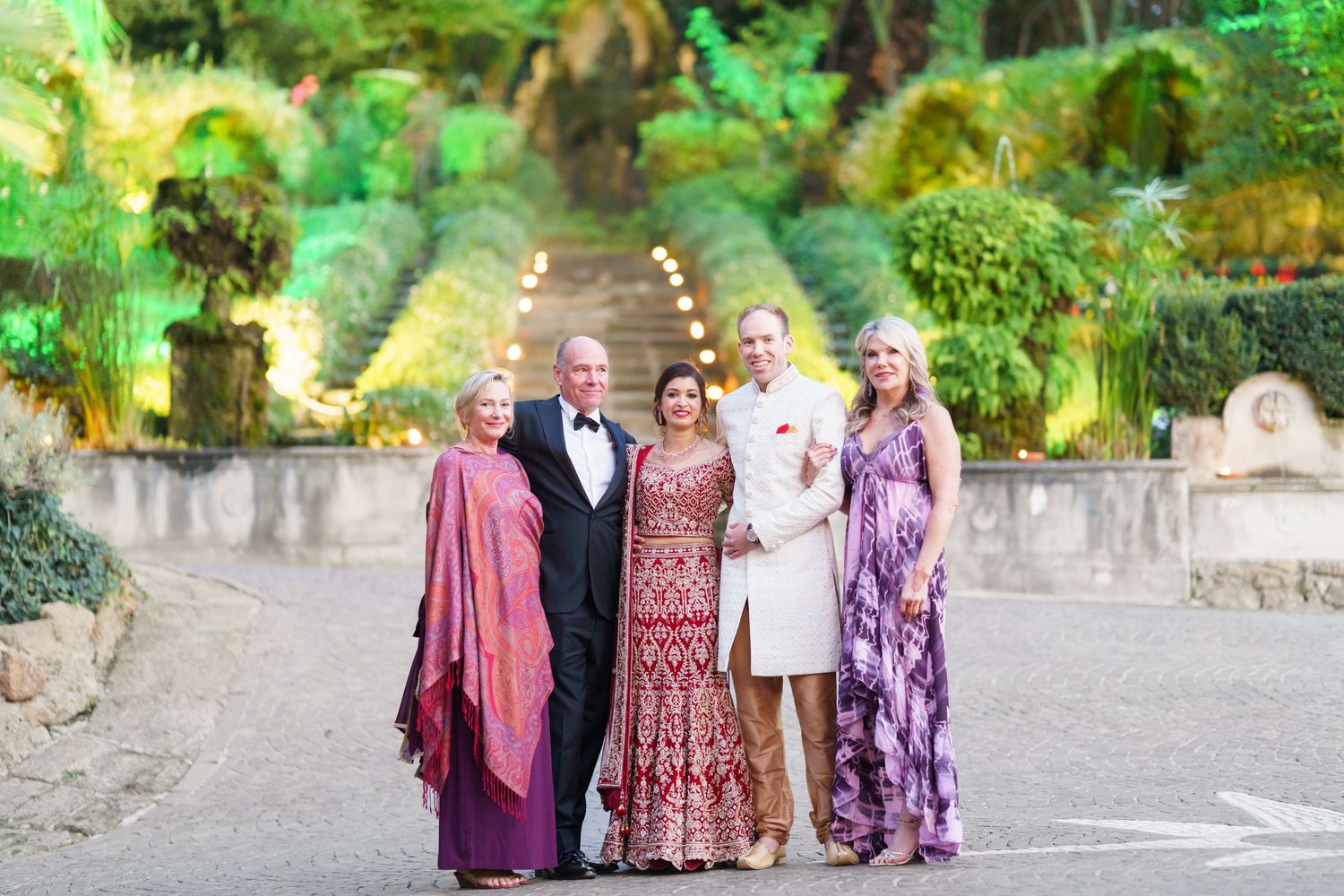 Friends gathered for a group photo in a tropical garden setting wearing coordinated outfits.