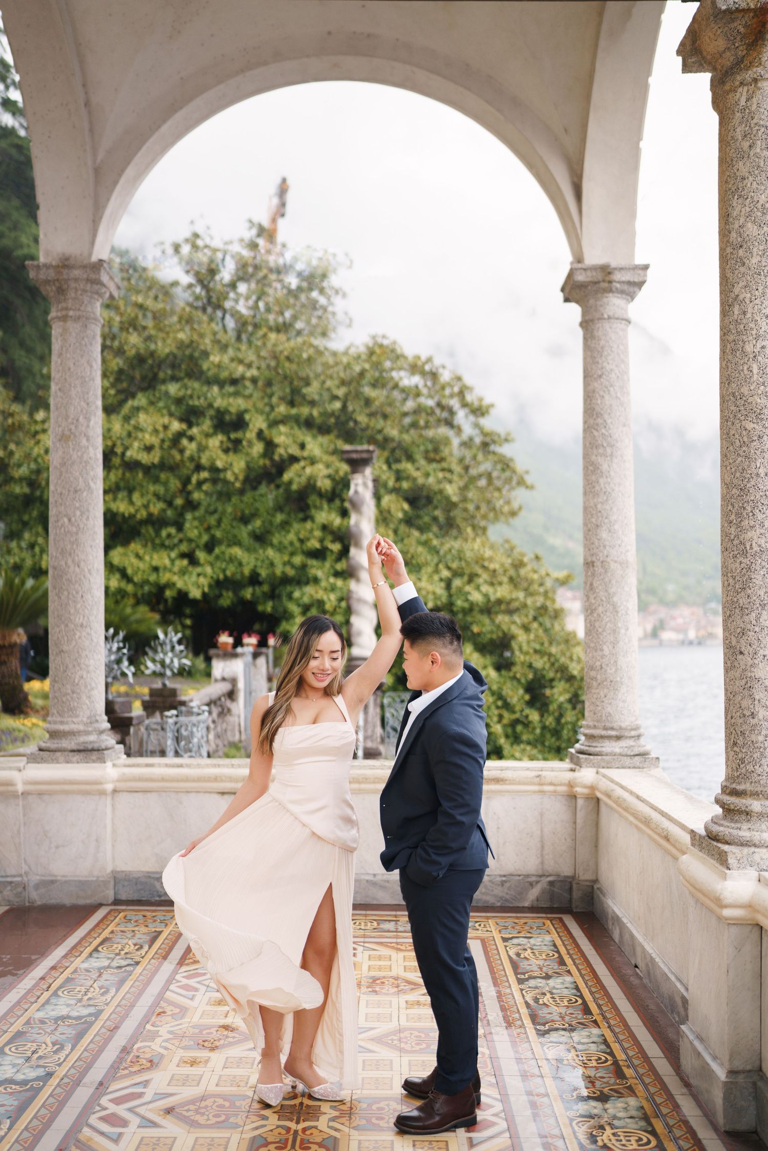 Lake Como proposal photographer capturing surprise engagement at Villa Monastero in Varenna