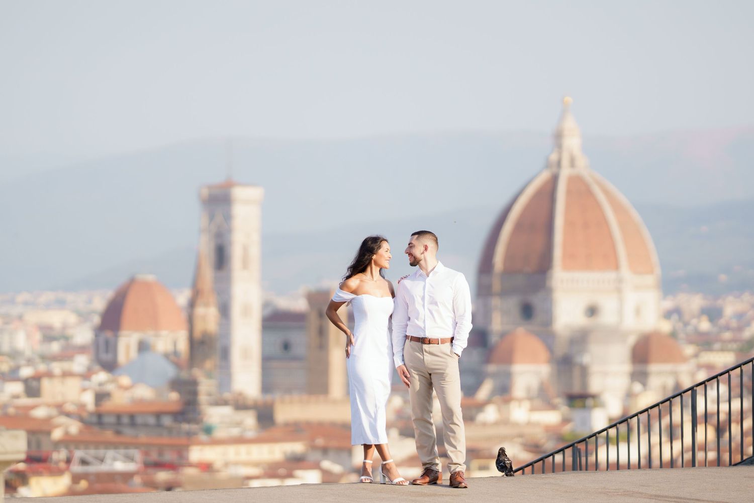 A romantic moment captured overlooking Florence's historic skyline with the Duomo cathedral visible below.