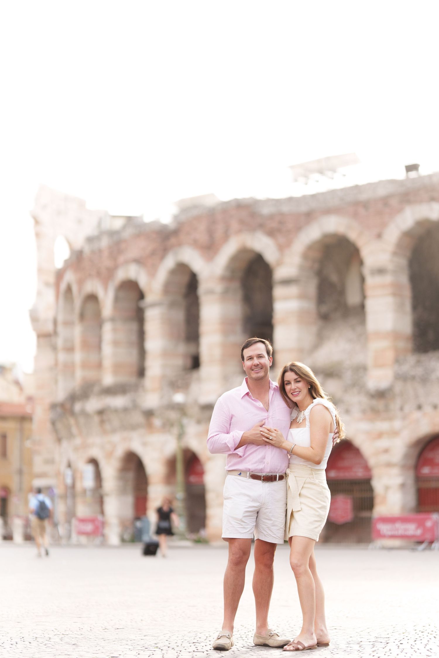 Verona family photographer family walking in front of Verona Arena Italy