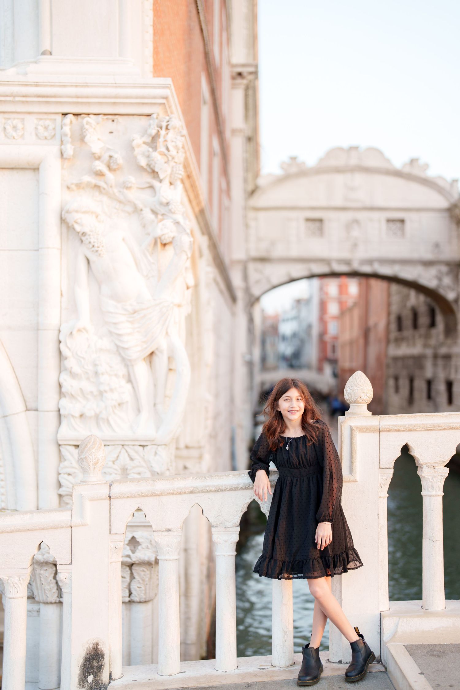 Scenic view of Venice's Bridge of Sighs with ornate stone architecture and canal in the background.
