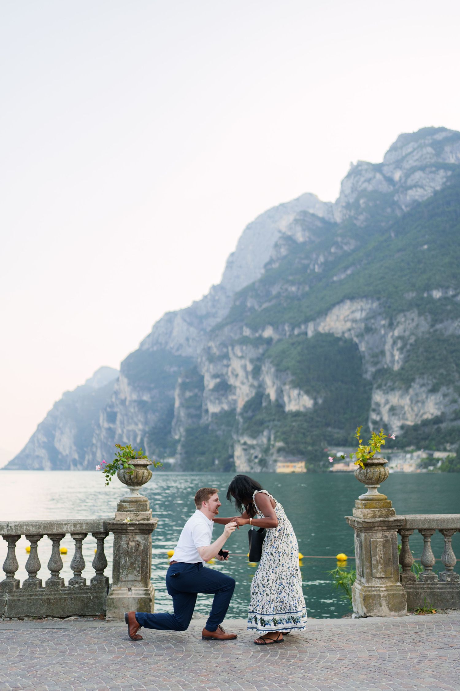 Surprise marriage proposal on one knee overlooking Lake Garda in Riva del Garda, Italy