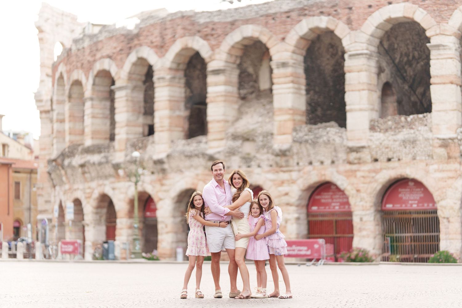 Verona family photographer family walking in front of Verona Arena Italy