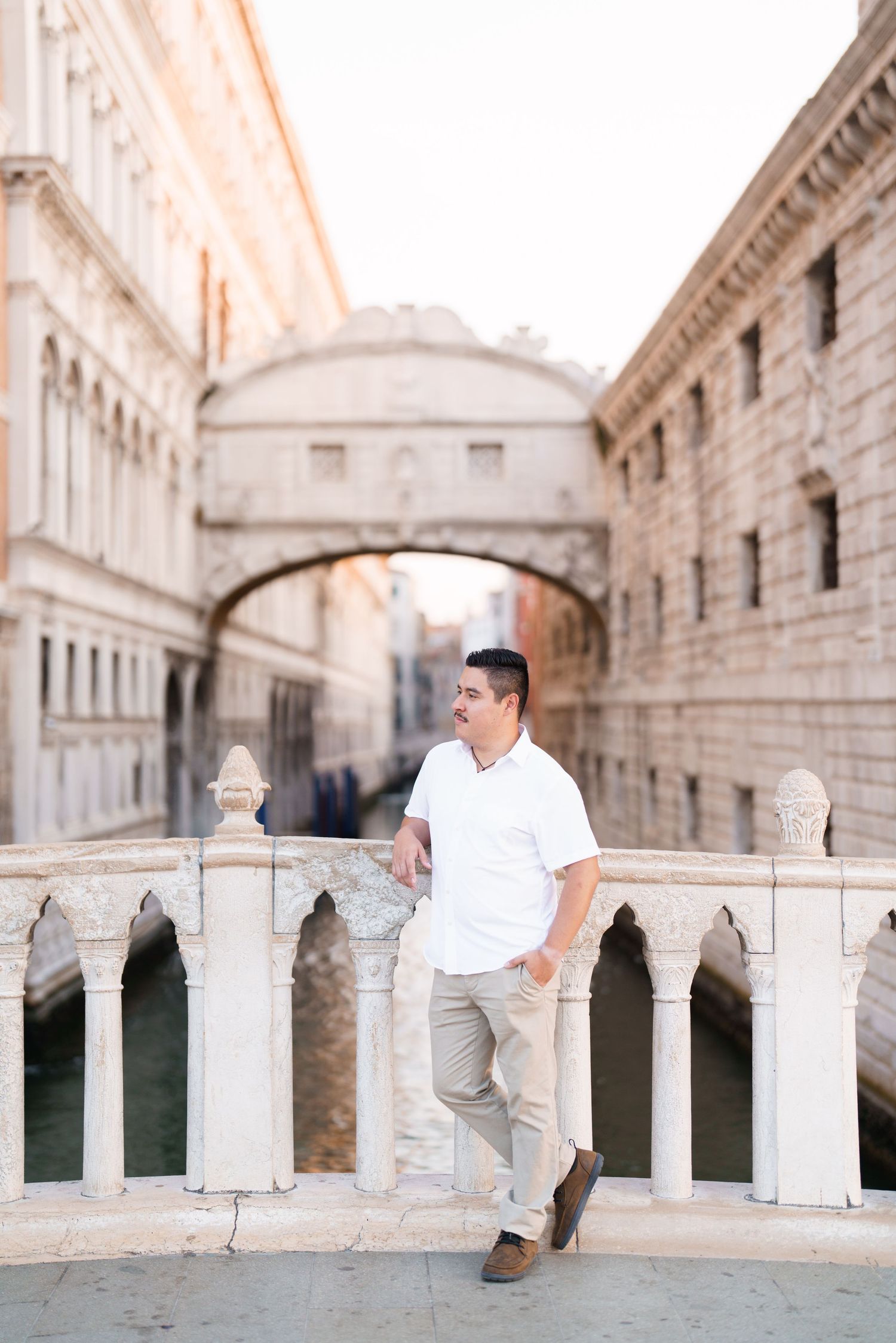 Romantic engagement photo session in Venice with the Bridge of Sighs and ornate architecture in the background.