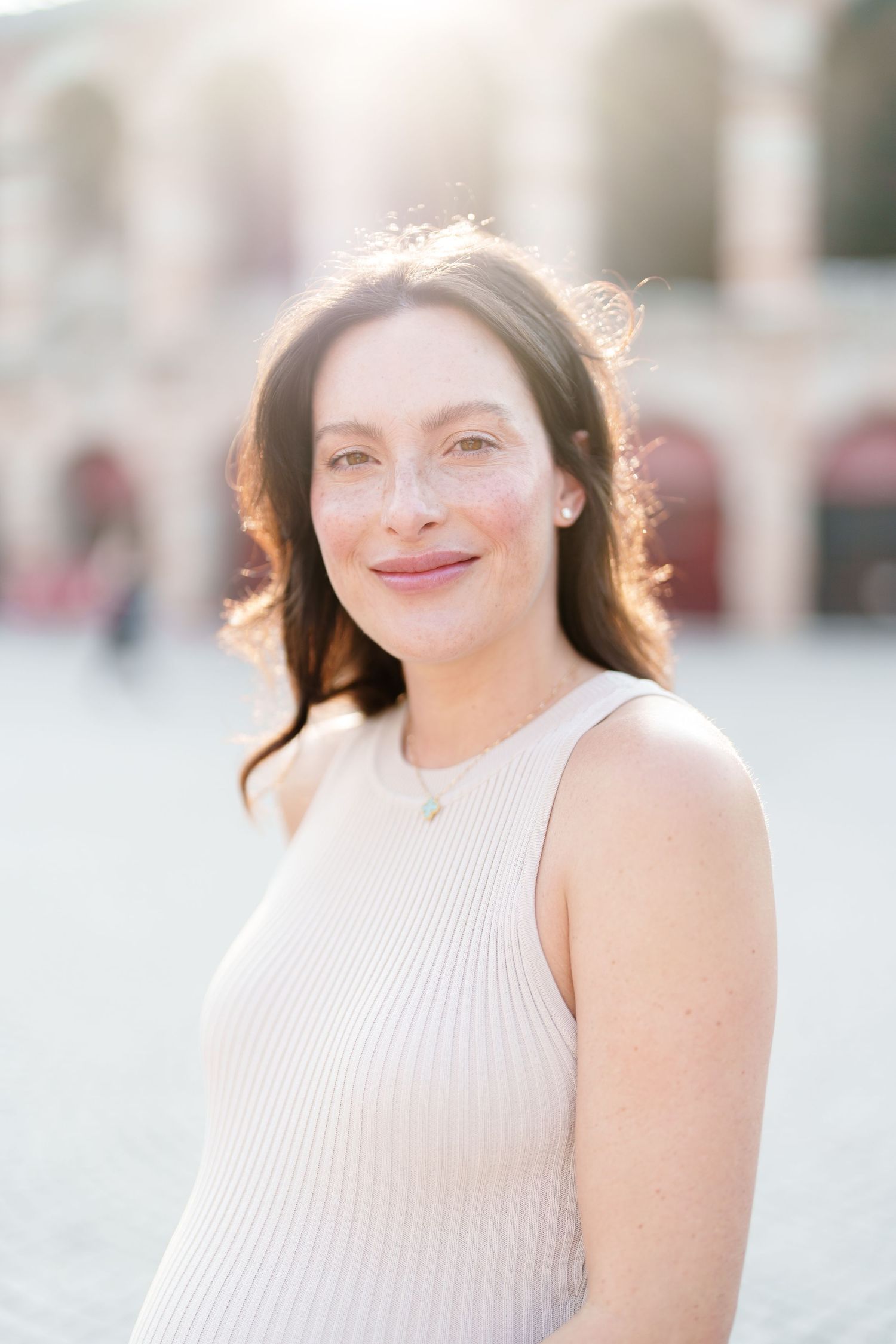 A series of outdoor portrait photos showing someone in a white ribbed sleeveless top with soft lighting and blurred backgrounds.