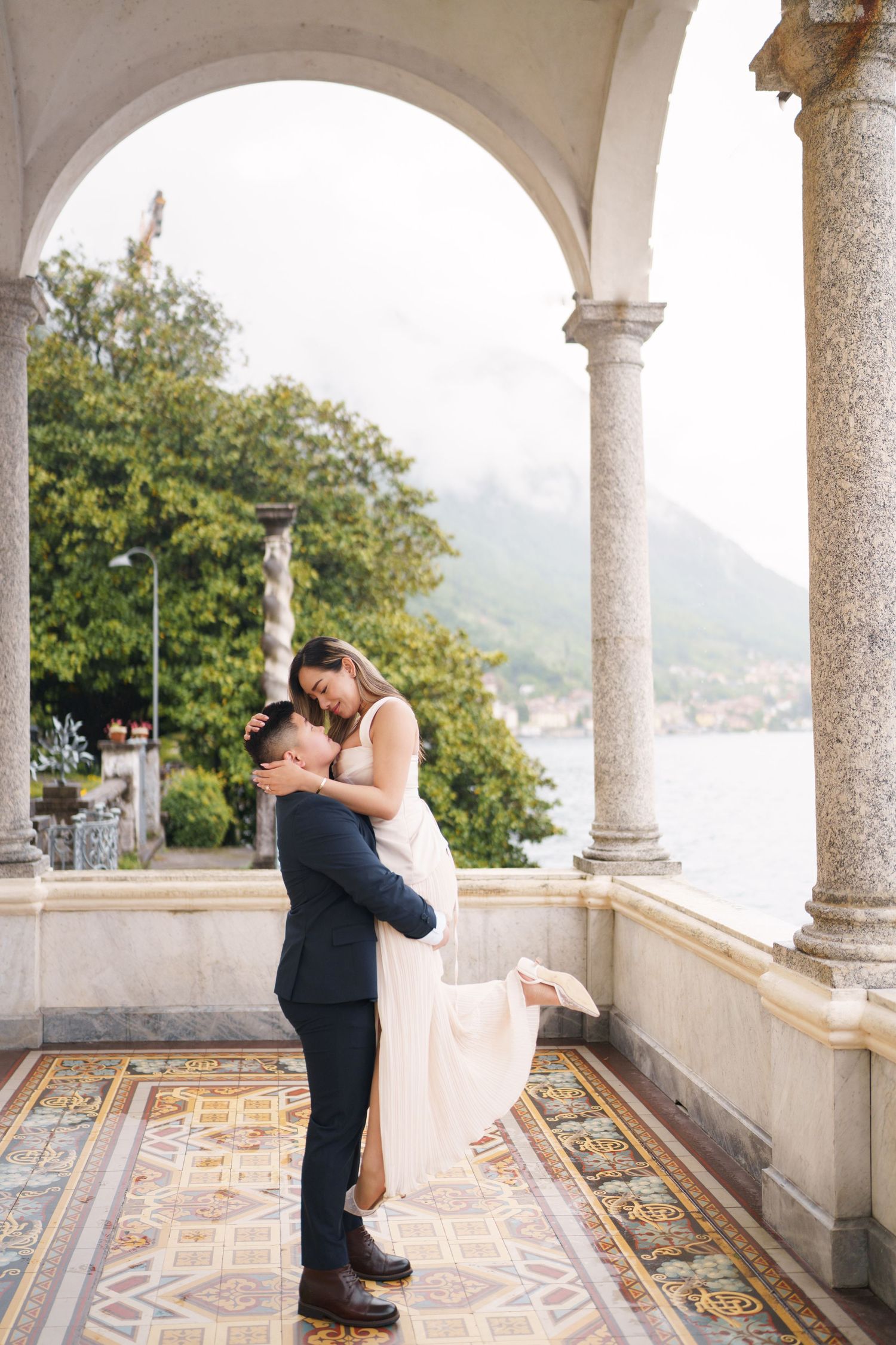 Lake Como proposal photographer capturing surprise engagement at Villa Monastero in Varenna