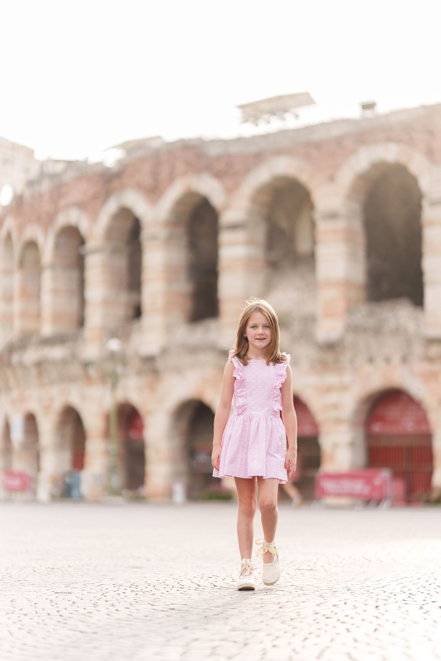 Verona family photographer family walking in front of Verona Arena Italy