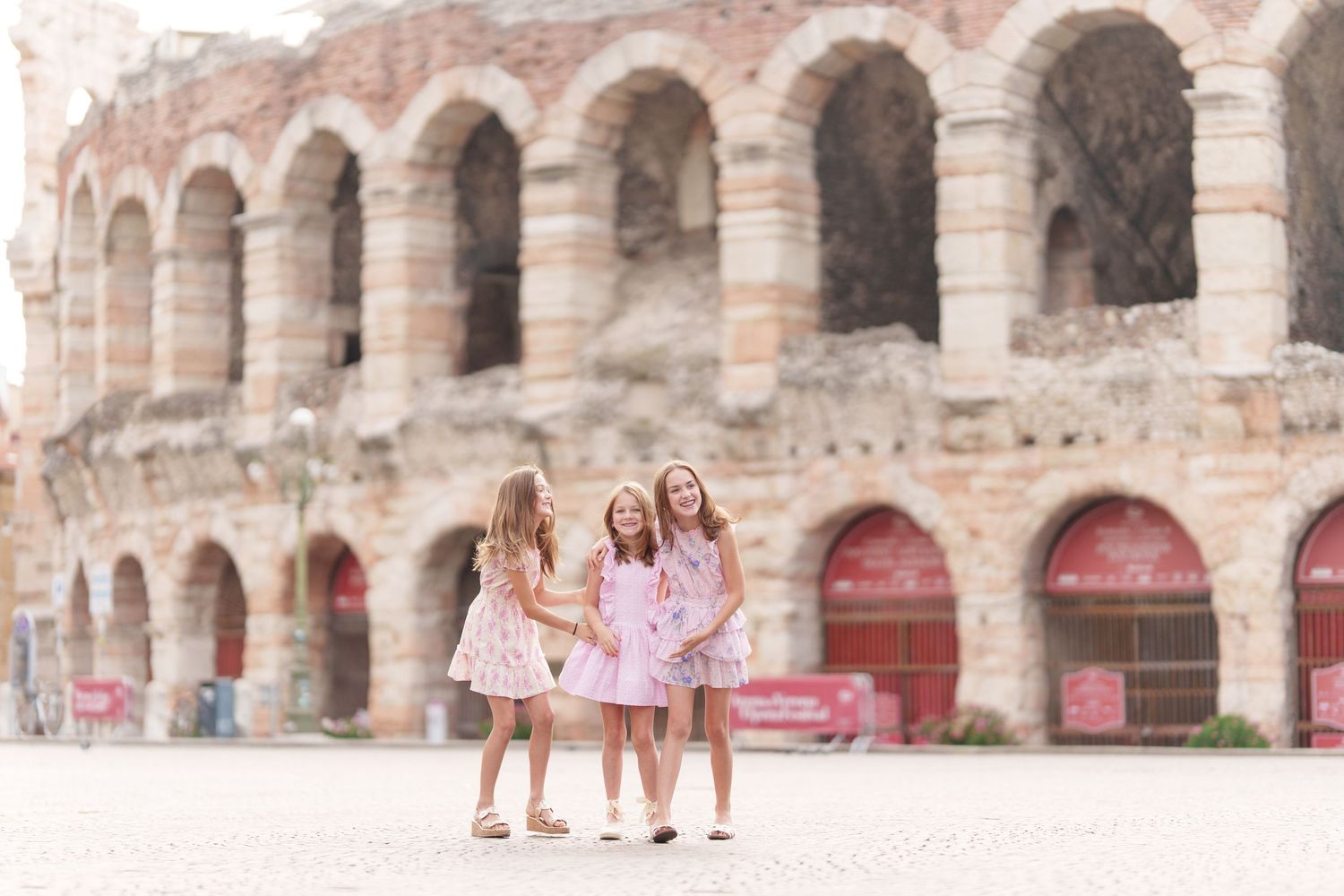 Verona family photographer family walking in front of Verona Arena Italy