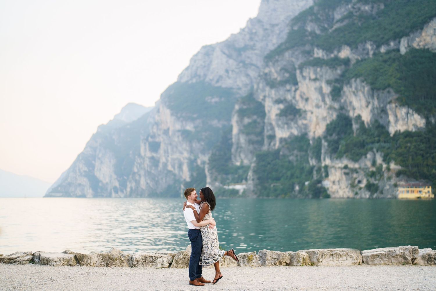 Emotional reaction during a surprise proposal beside Lake Garda in Riva del Garda