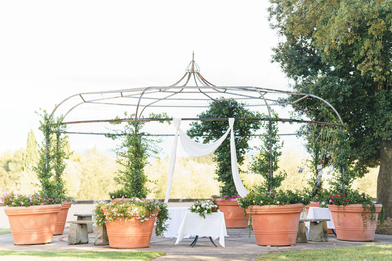 Outdoor terrace with terracotta planters and Mediterranean style architecture.