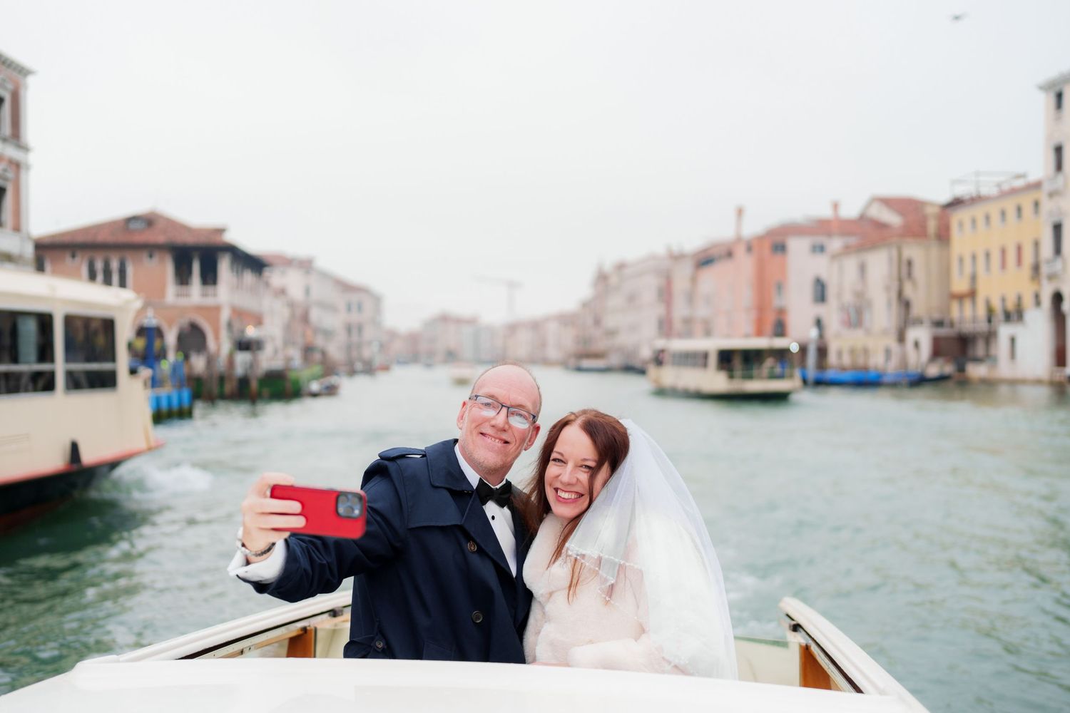 A couple shares a romantic moment in a gondola while exploring the scenic canals of Venice, Italy.