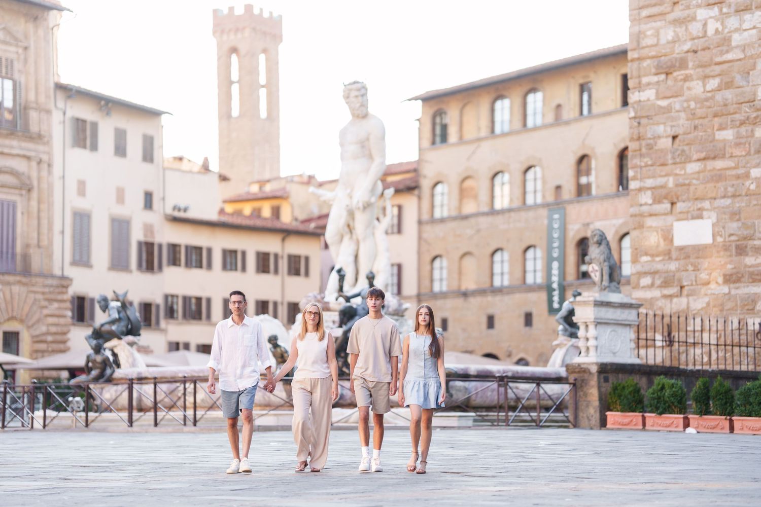 Panoramic view of a historic Italian plaza with stone buildings and medieval towers in Florence.