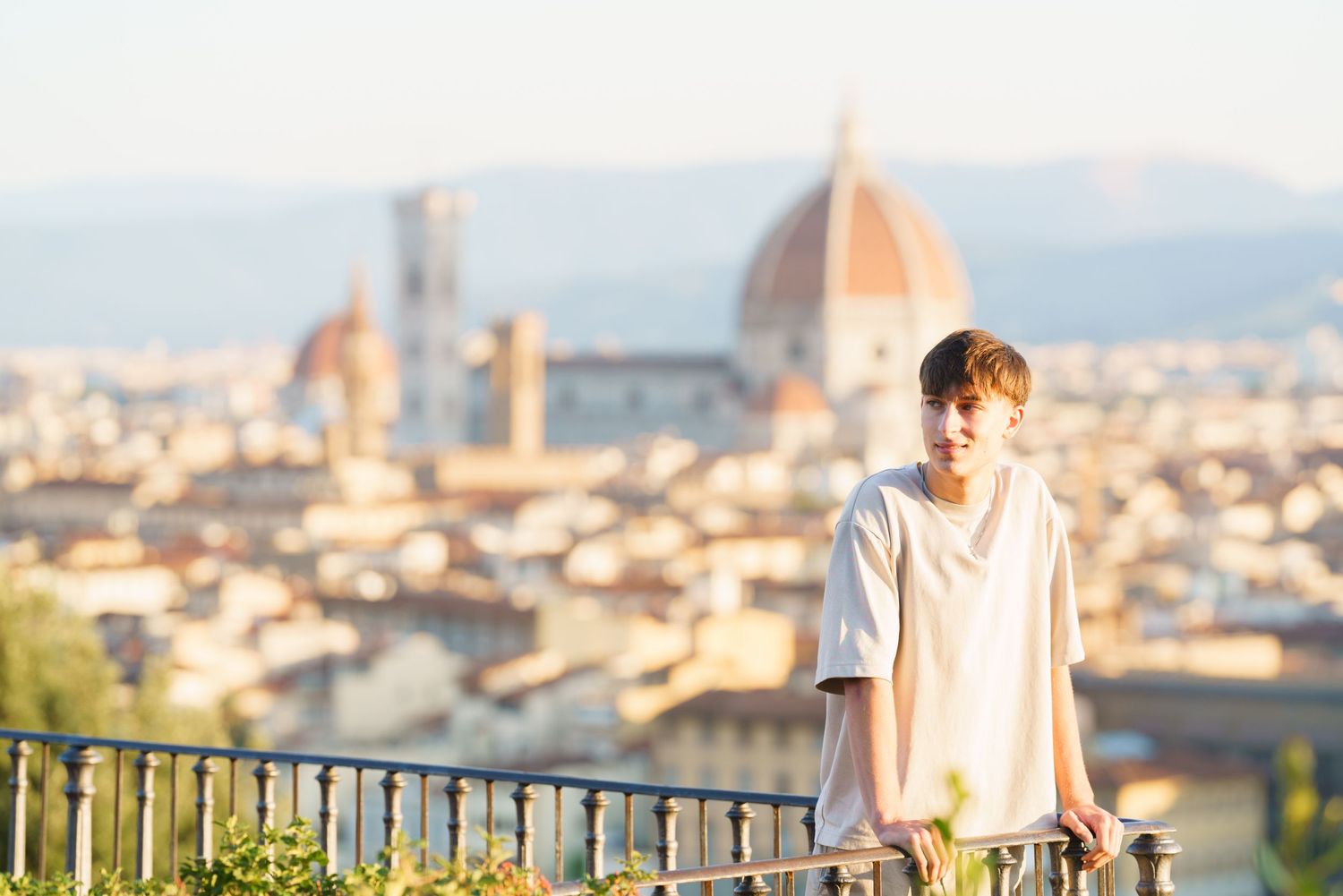 photographer Florence A person admires the stunning panoramic view of Florence, Italy from Piazzale Michelangelo at sunset.