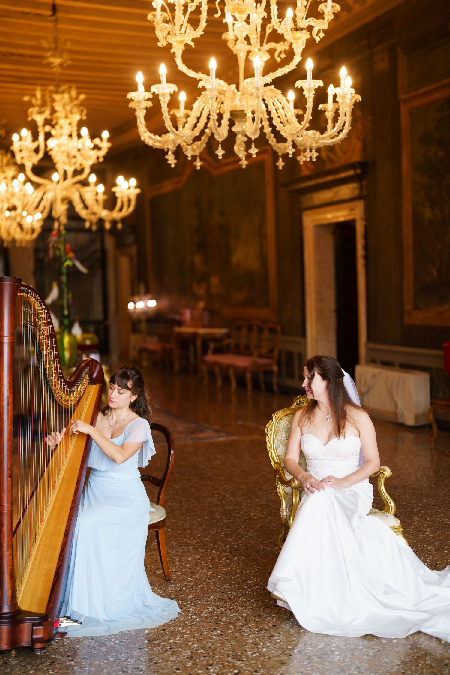 A series of elegant photos showing a harpist performing in a grand chandelier-lit ballroom.