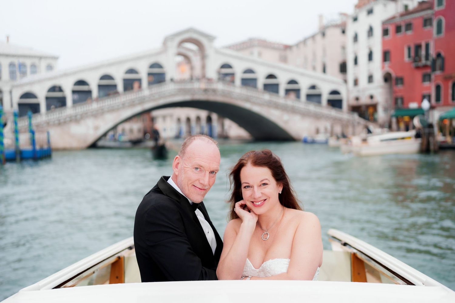 A couple shares a romantic moment while riding in a gondola through the scenic canals of Venice, Italy.