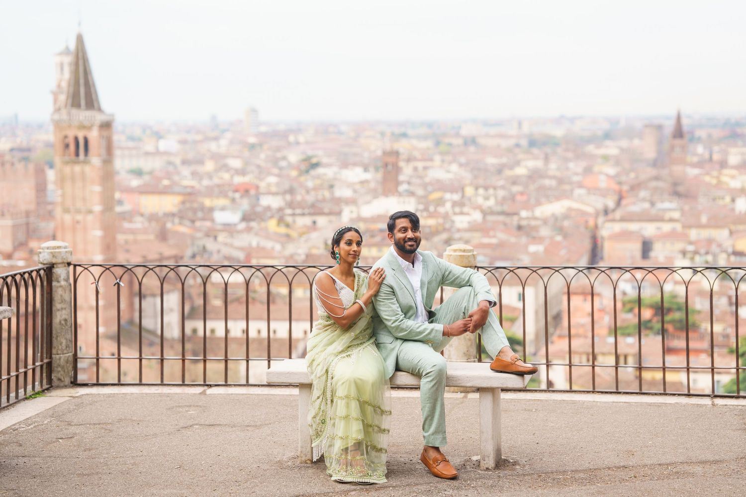 Two people enjoy a scenic overlook of Florence, Italy with historic architecture and church spires in the background.