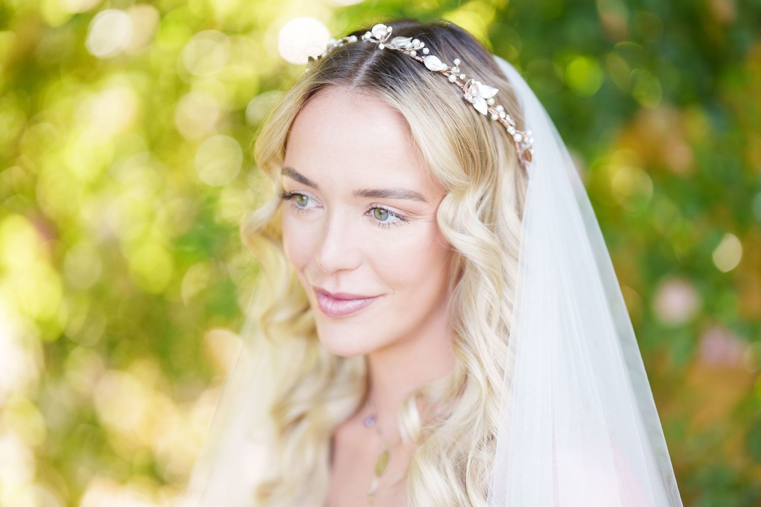Bride with wavy blonde hair wearing a floral crown and white veil, Italian lake wedding photographer