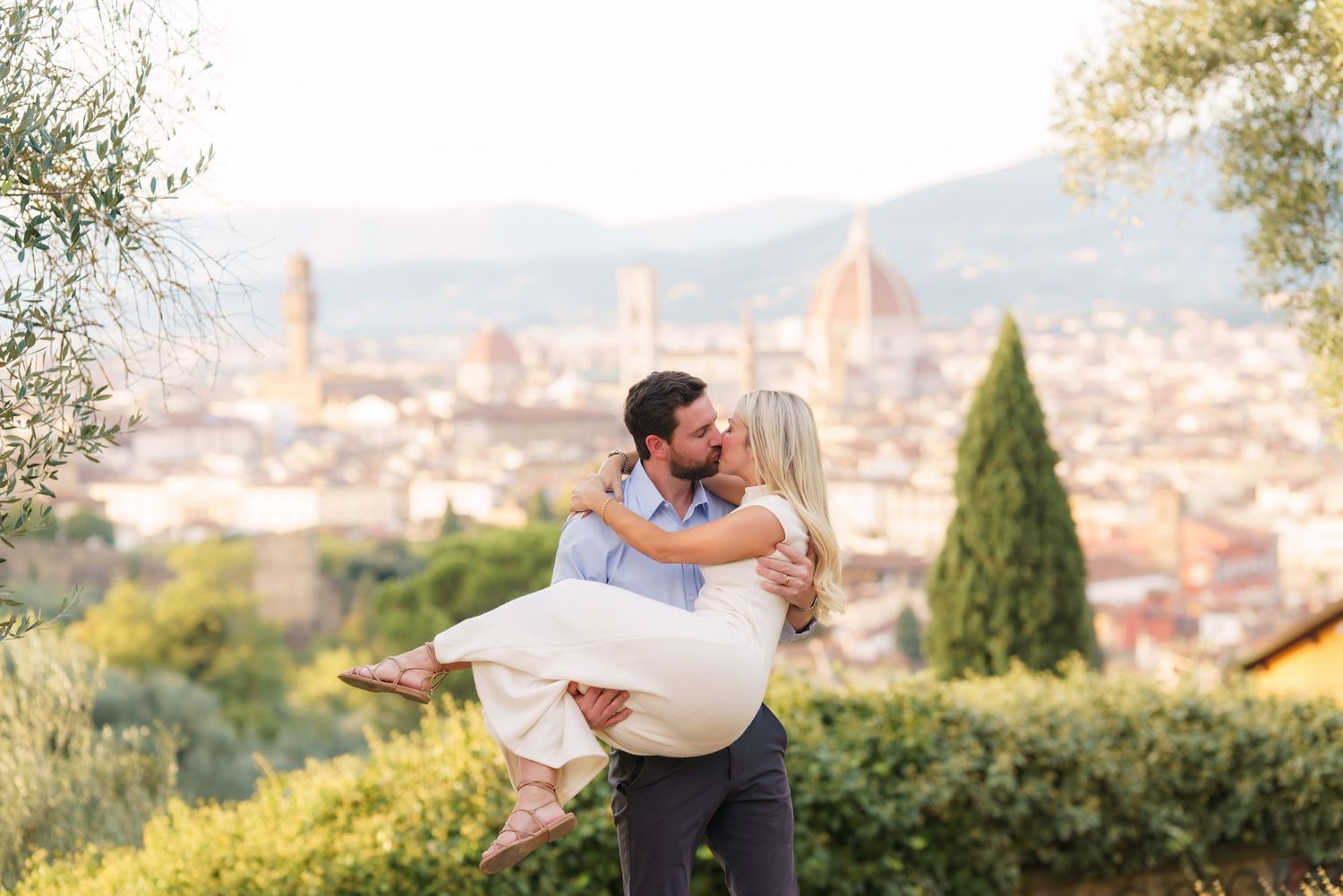 A romantic moment overlooking Florence, Italy with the iconic Duomo cathedral visible in the cityscape background.
