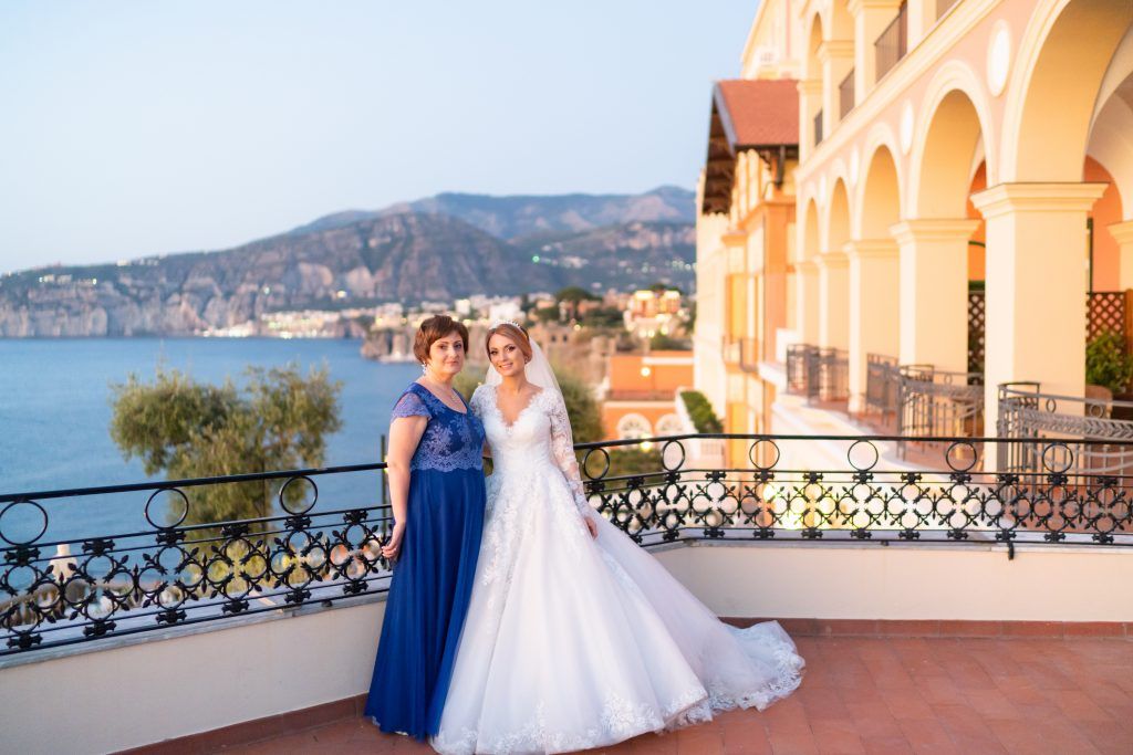 Elegant terrace overlooking the Mediterranean Sea with mountain views and classic architecture.