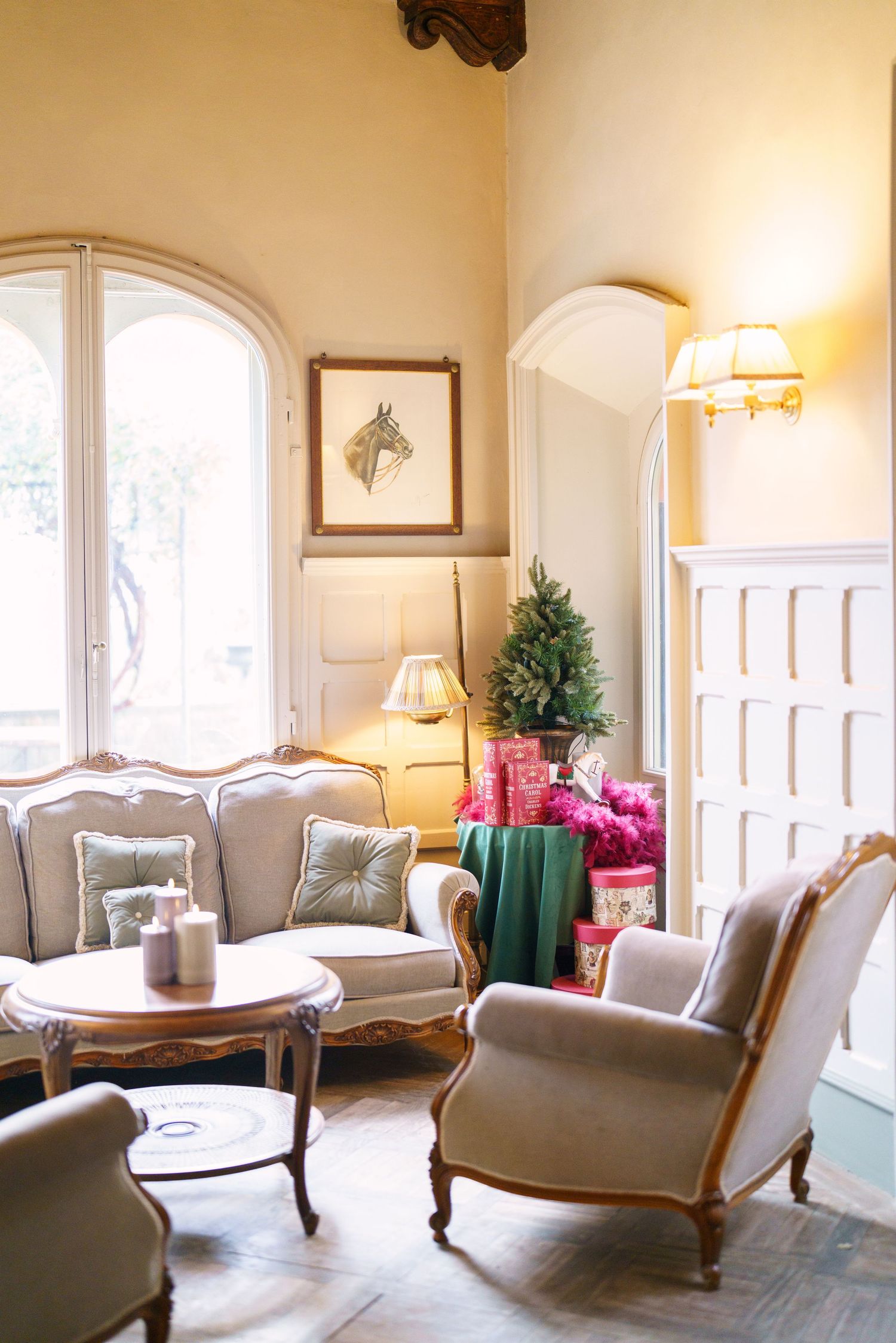 Luxurious lounge area featuring grey upholstered chairs and turquoise accent tables.