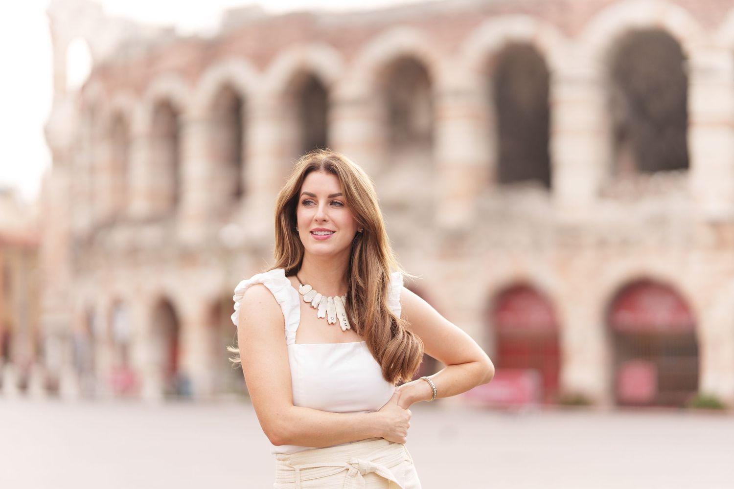 Verona family photographer family walking in front of Verona Arena Italy