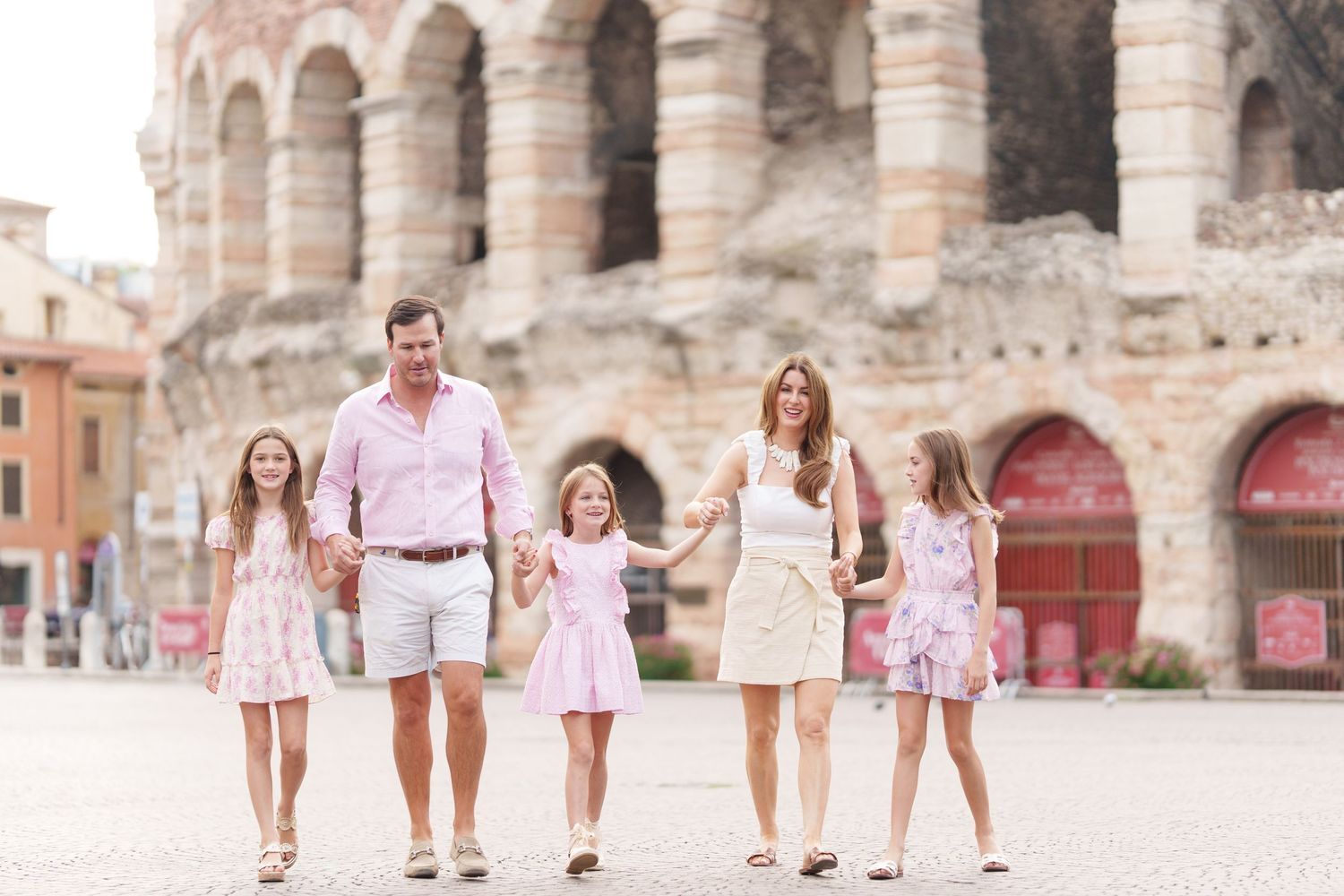 Verona family photographer family walking in front of Verona Arena Italy