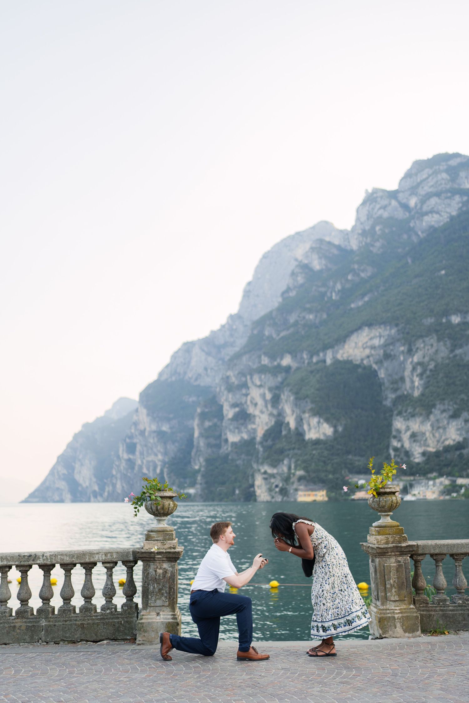 Surprise marriage proposal on one knee overlooking Lake Garda in Riva del Garda, Italy