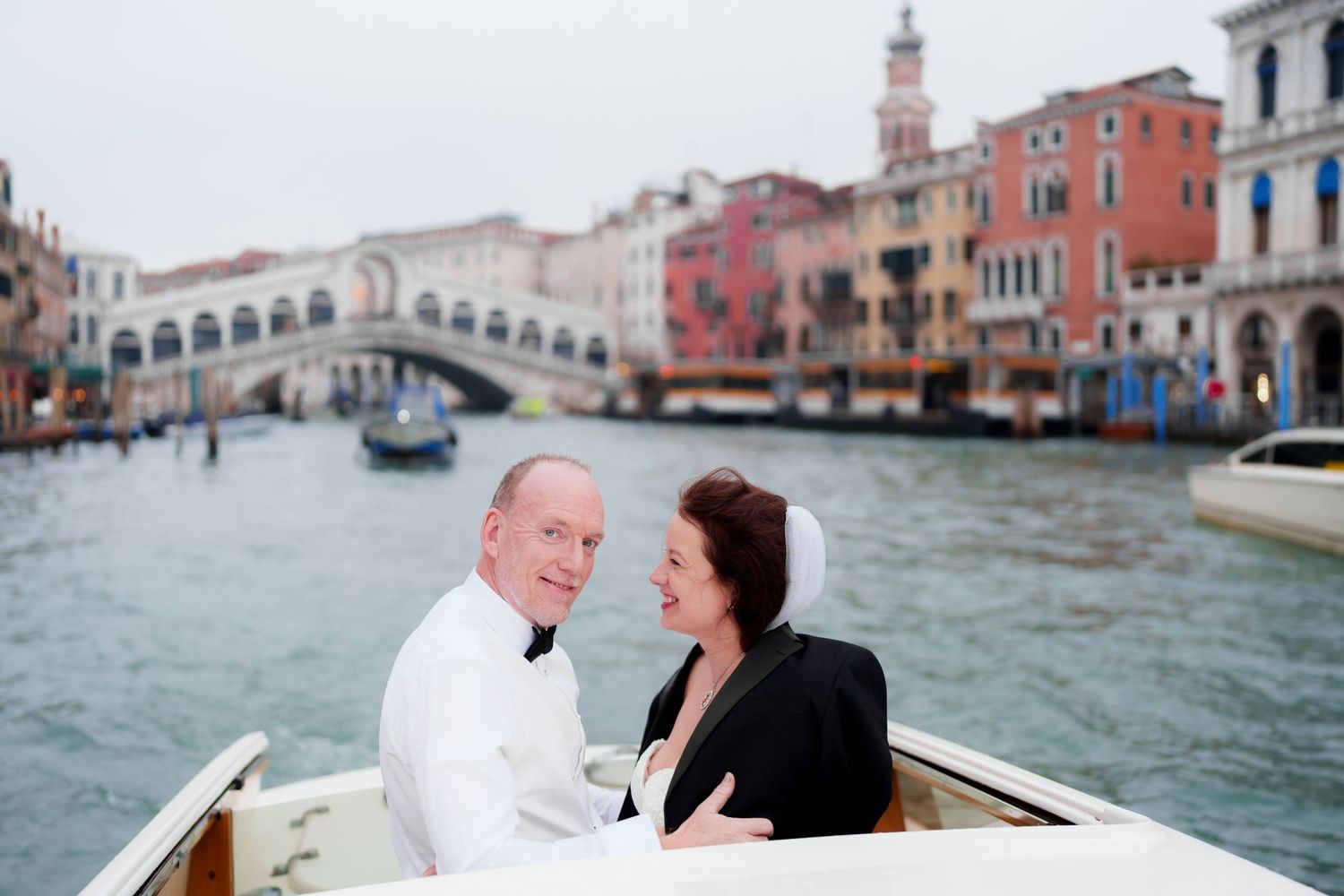 Romantic couple enjoying a scenic gondola ride through the picturesque canals of Venice, Italy.