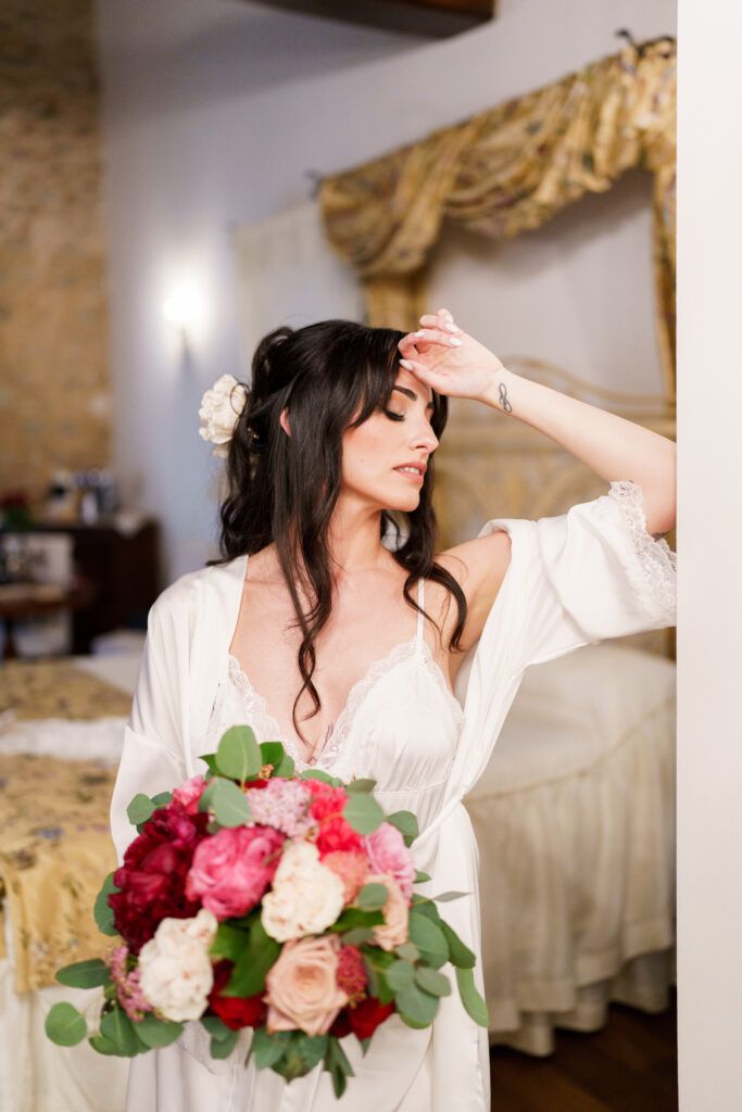 Beautiful bridal preparation scene with pink and red roses in a rustic setting.