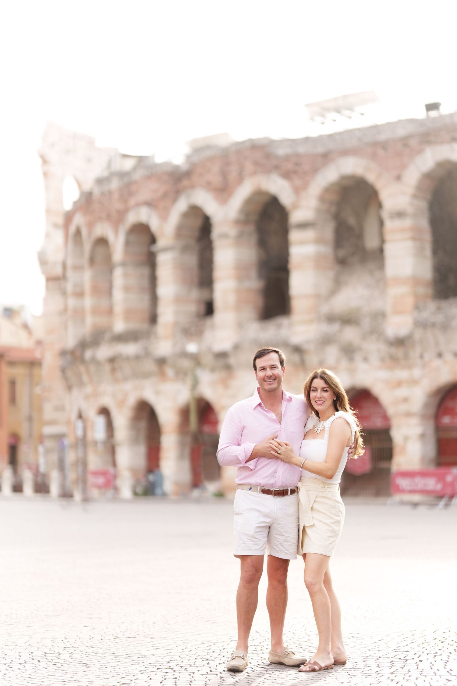 Verona family photographer family walking in front of Verona Arena Italy