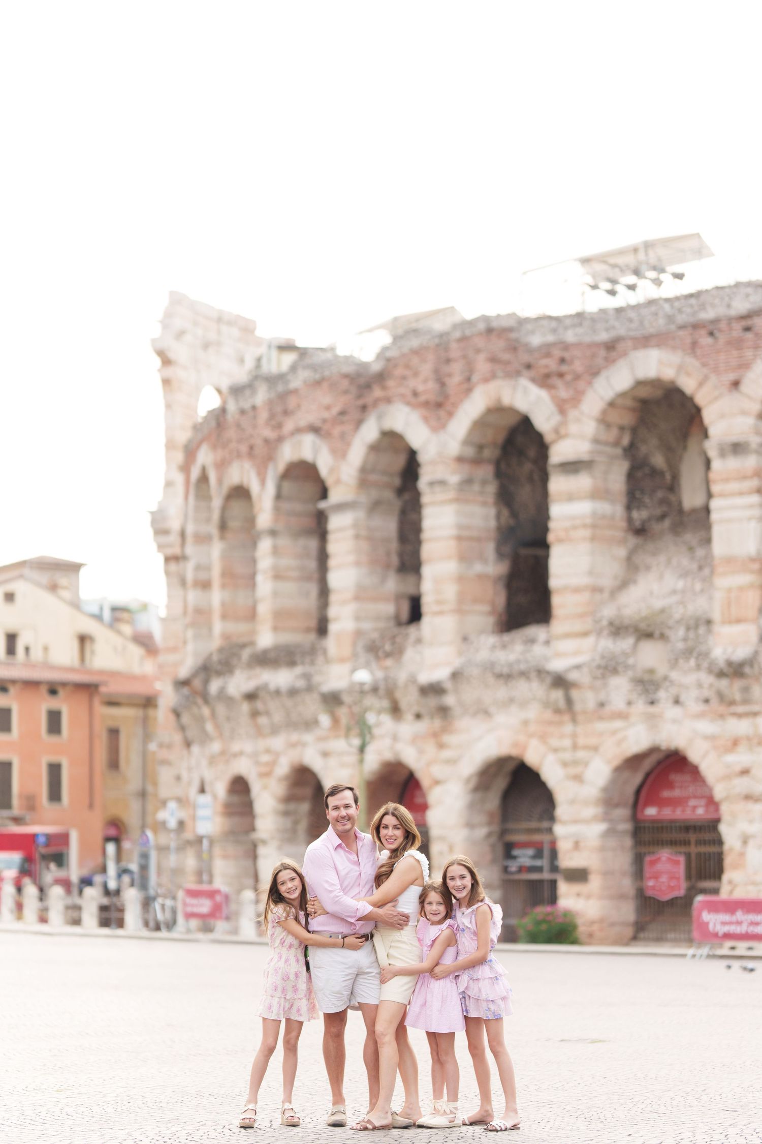 Verona family photographer family walking in front of Verona Arena Italy