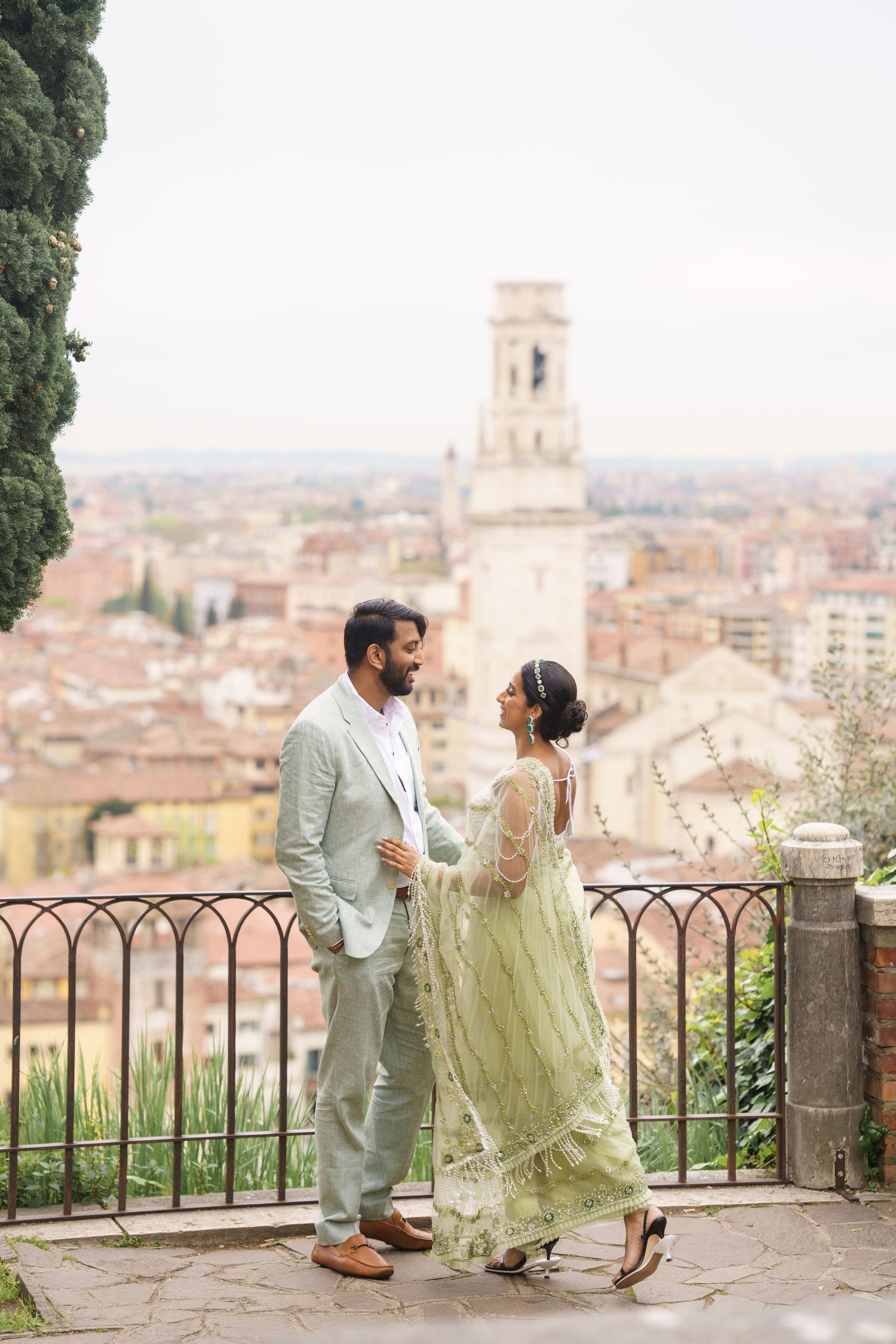 A couple shares a romantic moment overlooking the historic city of Florence from a scenic terrace viewpoint.